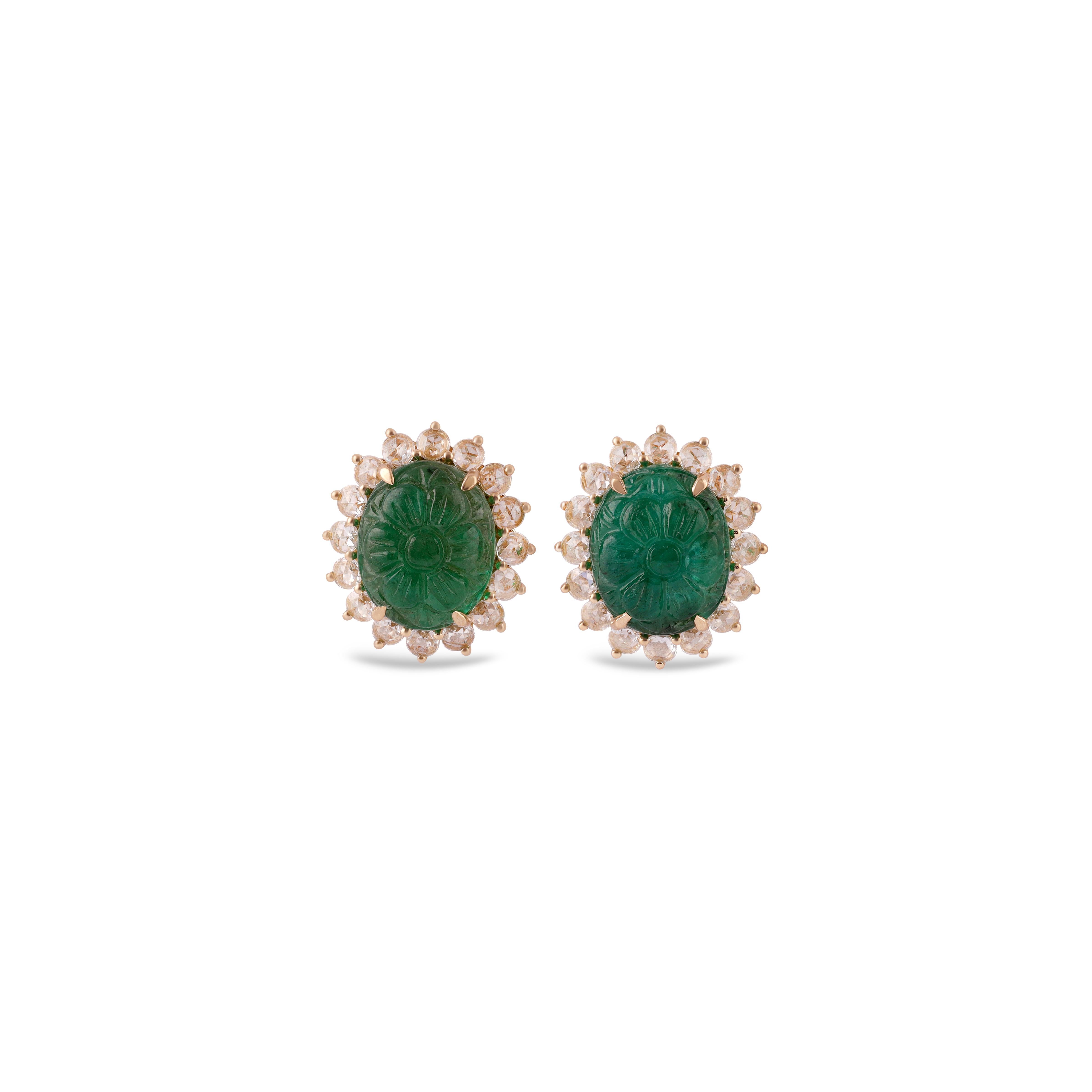 This is an elegant Carved emerald & diamond Earring studded in 18k Yellow gold with 2 piece of oval Cut  shaped  Carved Zambian emerald weight 12.37 carat which is surrounded by 32 pieces of round shaped diamonds weight 1.17 carat, this entire