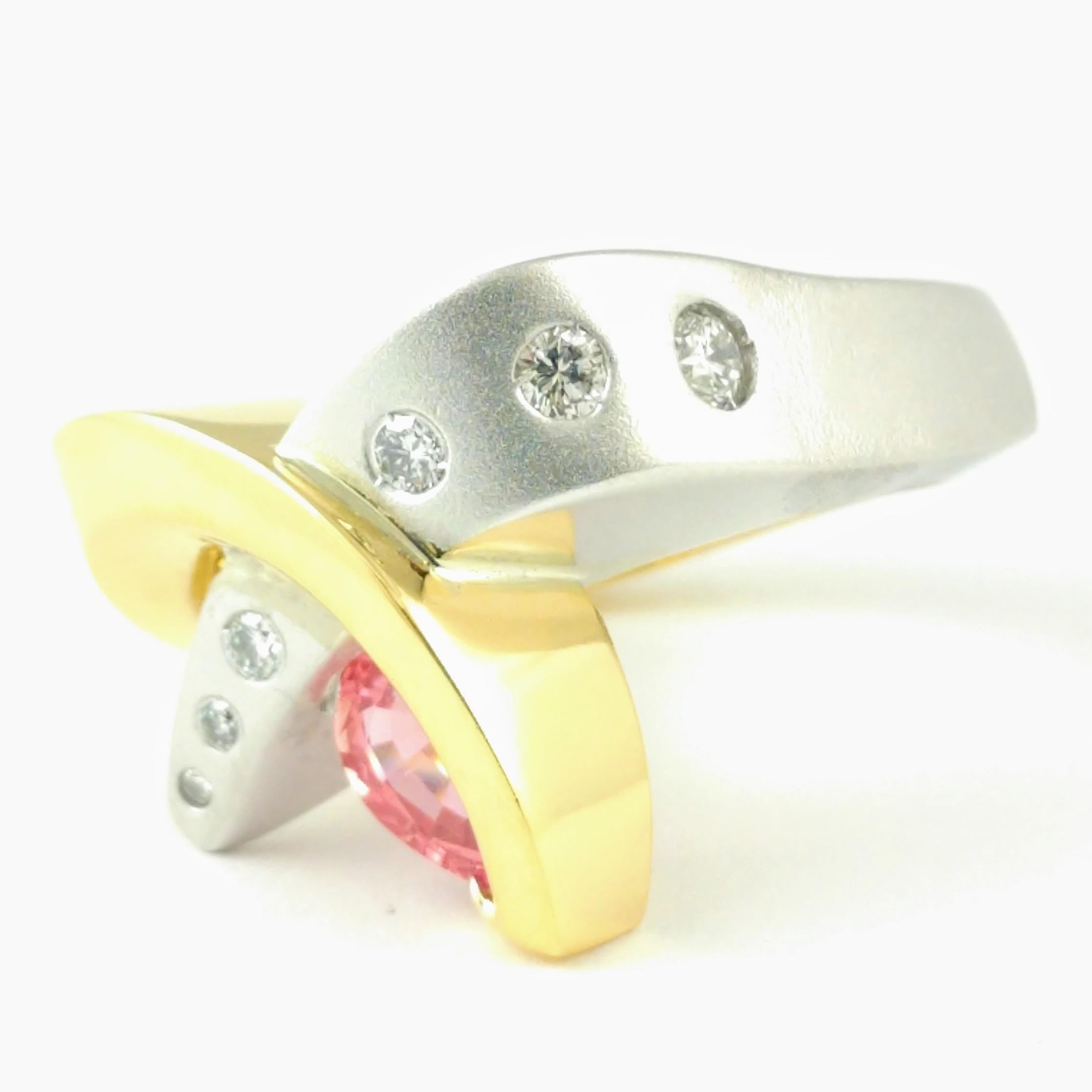 This original 18k yellow gold and 14k white gold designer swirl ring features a rare 1.23ct teardrop shaped Padparadscha Sapphire gemstone exhibiting vivid orange-pink tones. There are 6 round brilliant accent diamonds with a total diamond weight of