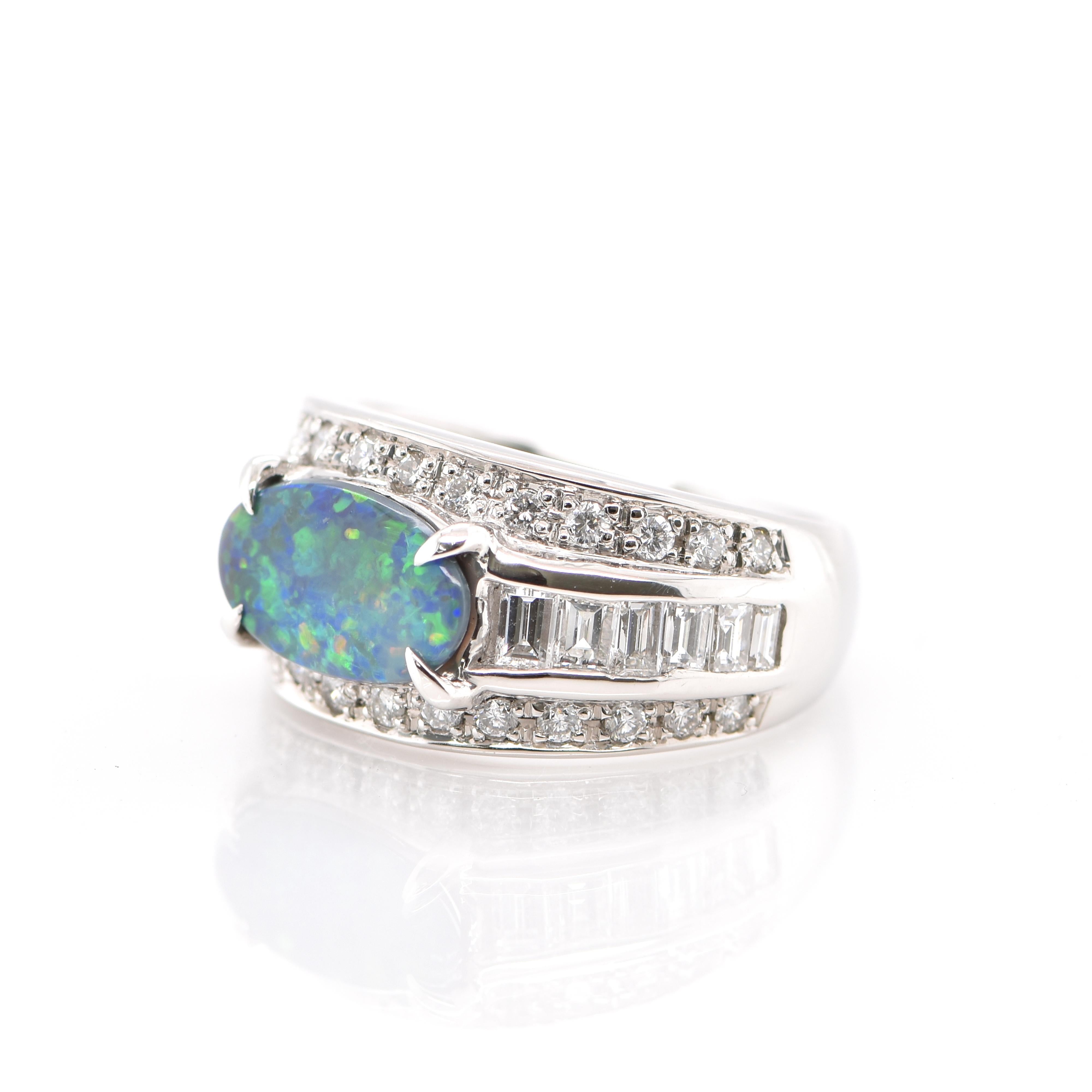 A beautiful Cocktail Ring featuring a 1.24 Carat Natural Australian Black Opal and 1.97 Carats of Diamond Accents set in Platinum. Opals are known for exhibiting flashes of rainbow colors known as 