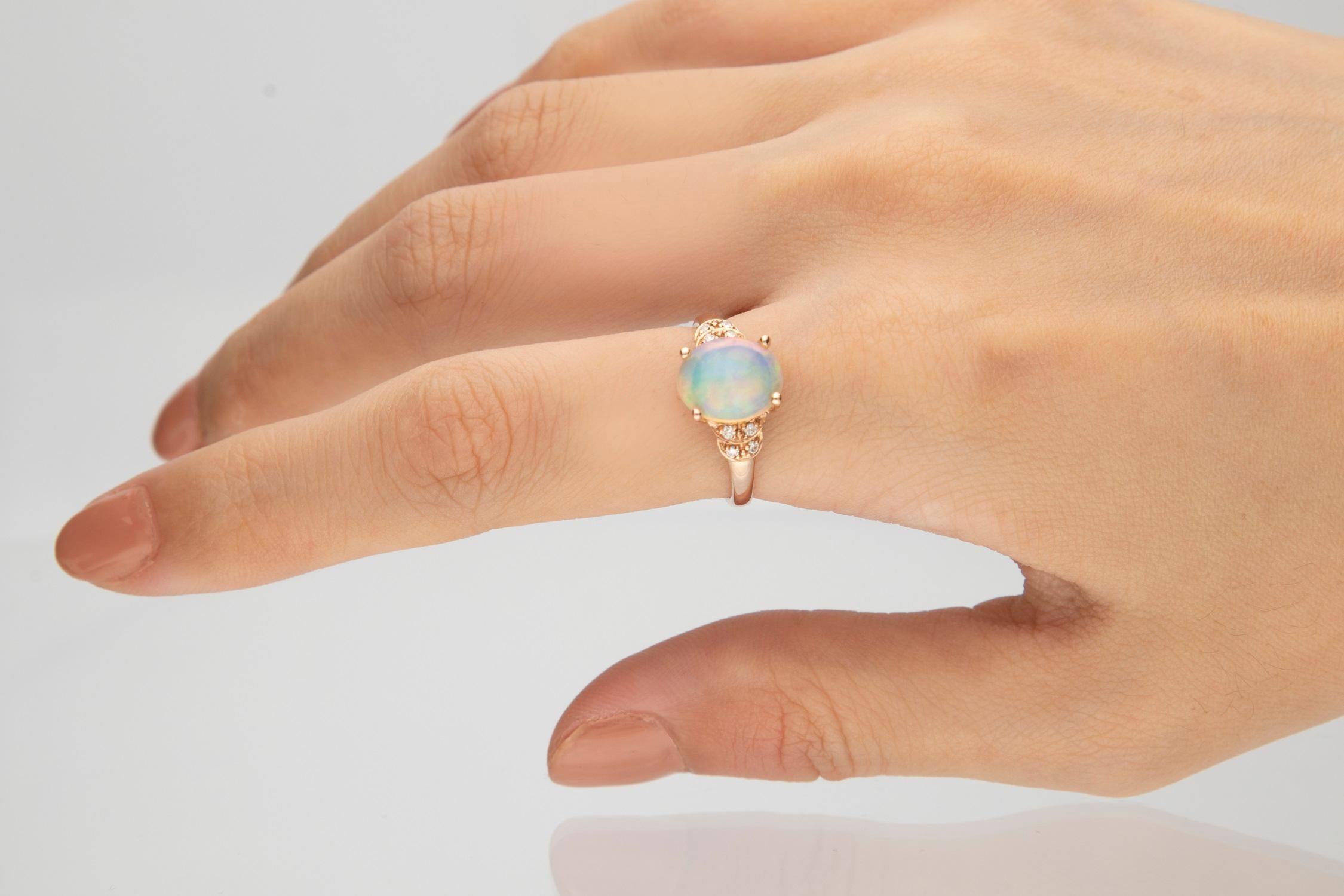 A gorgeous oval-cut Australian Opal gemstone centers this remarkable Gin & Grace ring and accented with round-cut diamonds on its sides. Crafted of beautiful 10-karat rose gold, this ring shines with a highly polished finish. Gemstone colors: White
