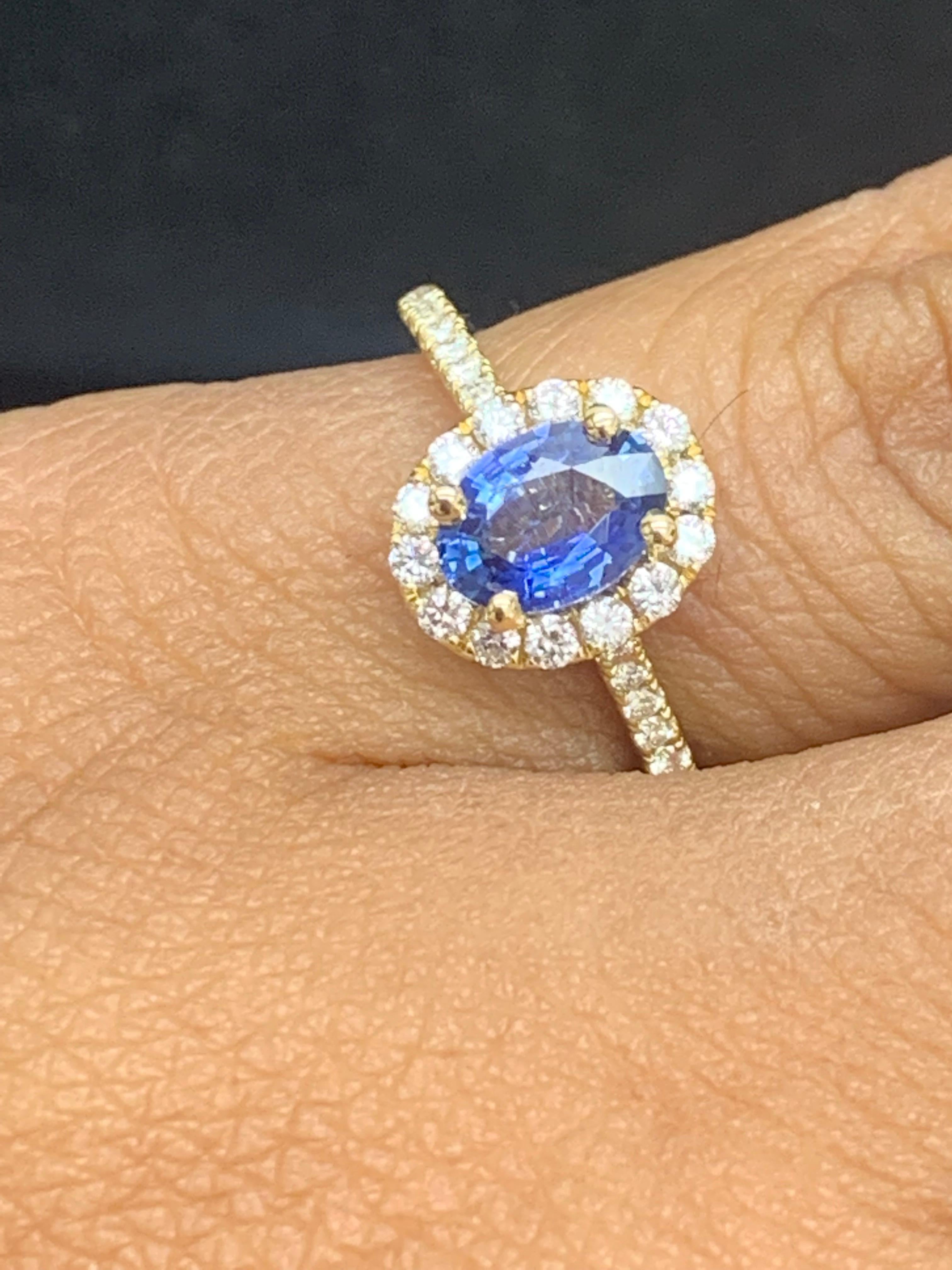 This is a unique ring showcasing a 1.24-carat Oval-shaped sapphire. Surrounding the center stone is an elegant halo of sparkling round diamonds. More round diamonds accent the 18K yellow gold mounting. 34 Accent diamonds weigh 0.56 carats total.