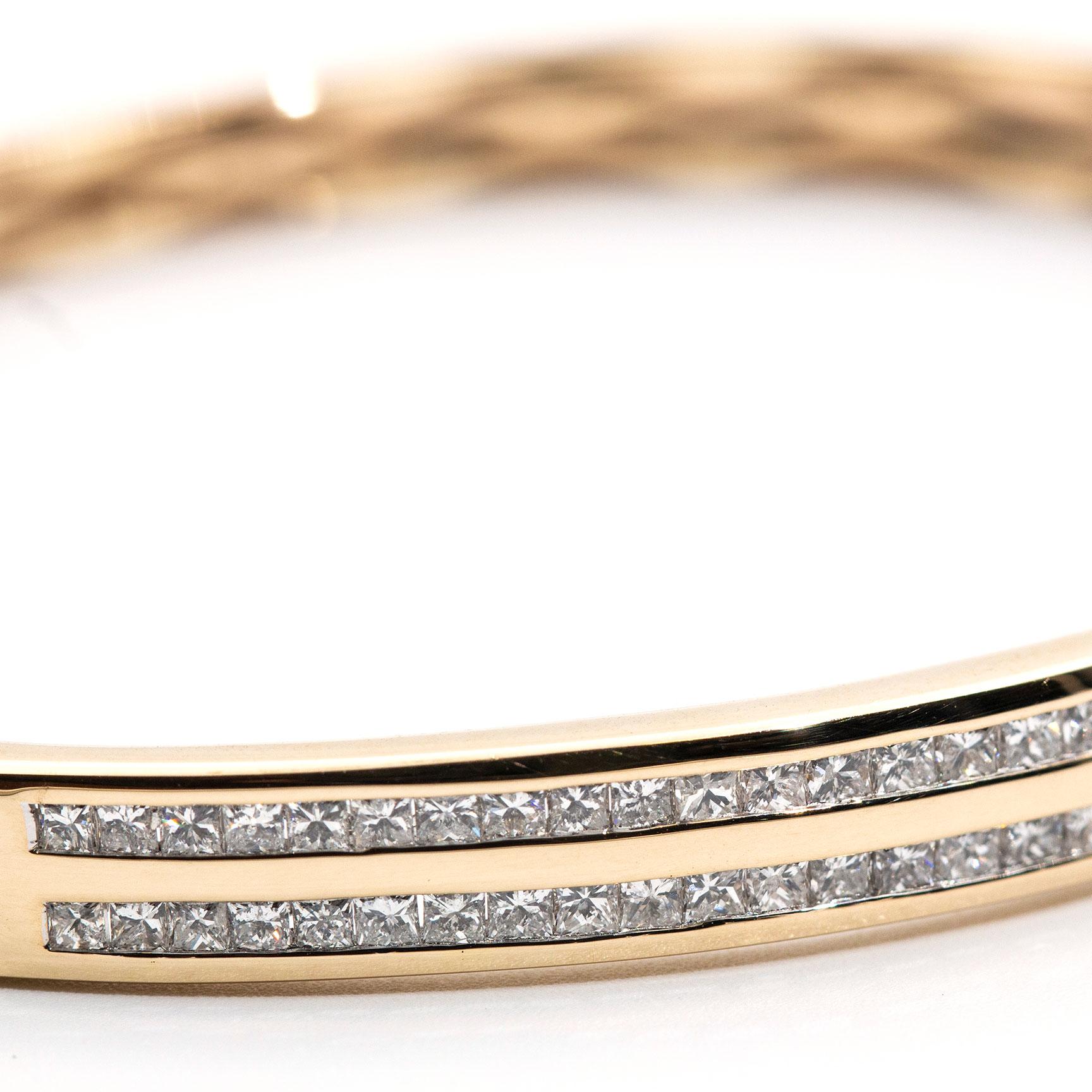 This luxurious vintage oval hinged bangle is forged in 9 carat yellow gold and features two stunning rows of princess cut diamonds totalling 1.24 carat.  We bestowed the name The Lena Bangle to this vintage beauty.  The Lena Bangle is oval in shape