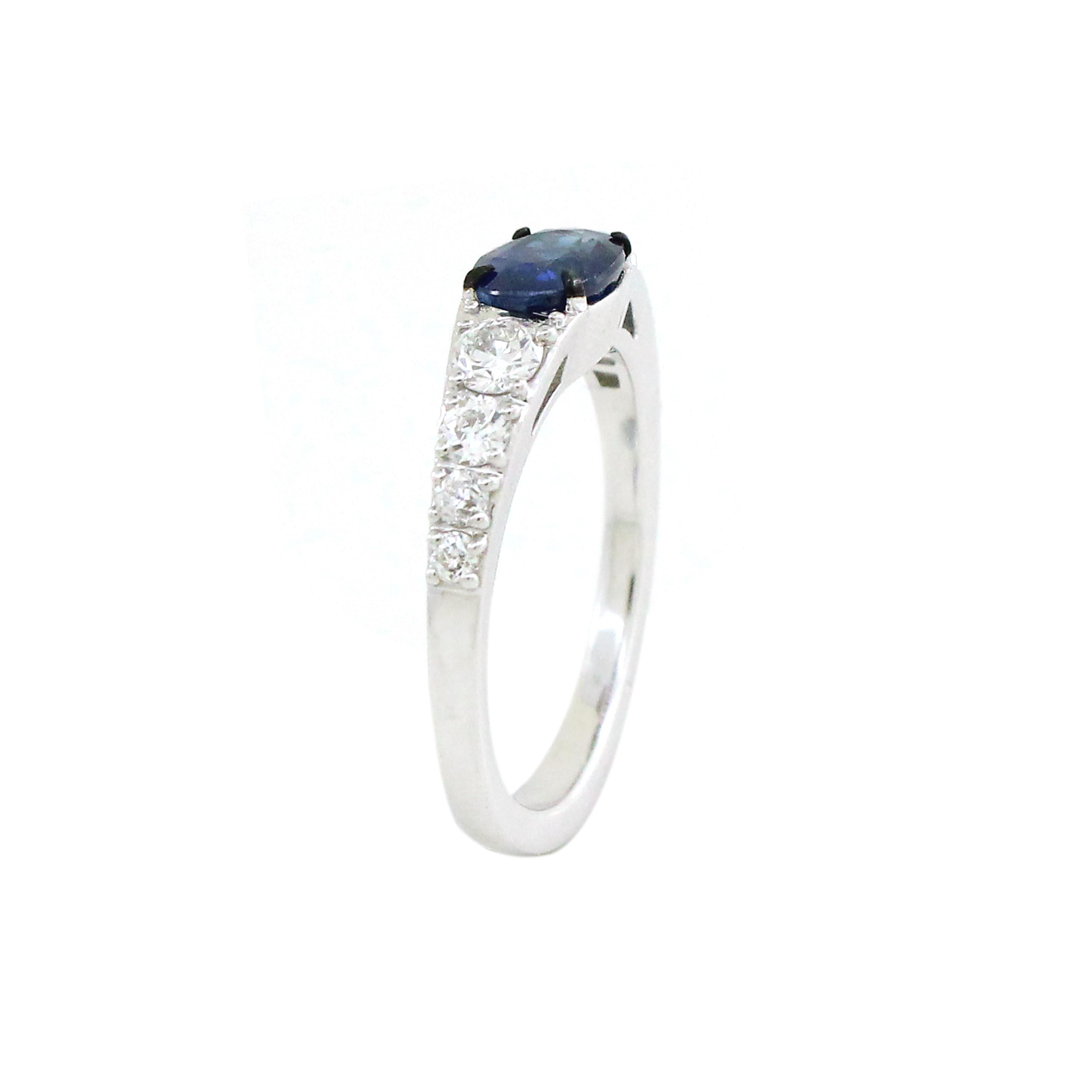 The focal point of this ring is a mesmerizing 1.24 carat oval cut sapphire, carefully selected for its exceptional color and clarity. Its deep, velvety blue hue evokes a sense of timeless allure, while the sapphire's graceful oval shape adds a touch