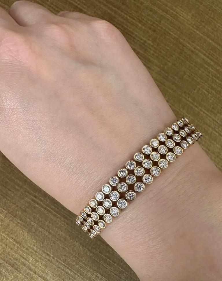 12.42 carats Three Row Diamond Bracelet in 18k Yellow Gold

Three Row Diamond Bracelet features over 12.42 carats of Round Brilliant Diamonds bezel set in highly polished 18k Yellow Gold.

Total diamond weight is 12.42 carats.

Bracelet is 7.25