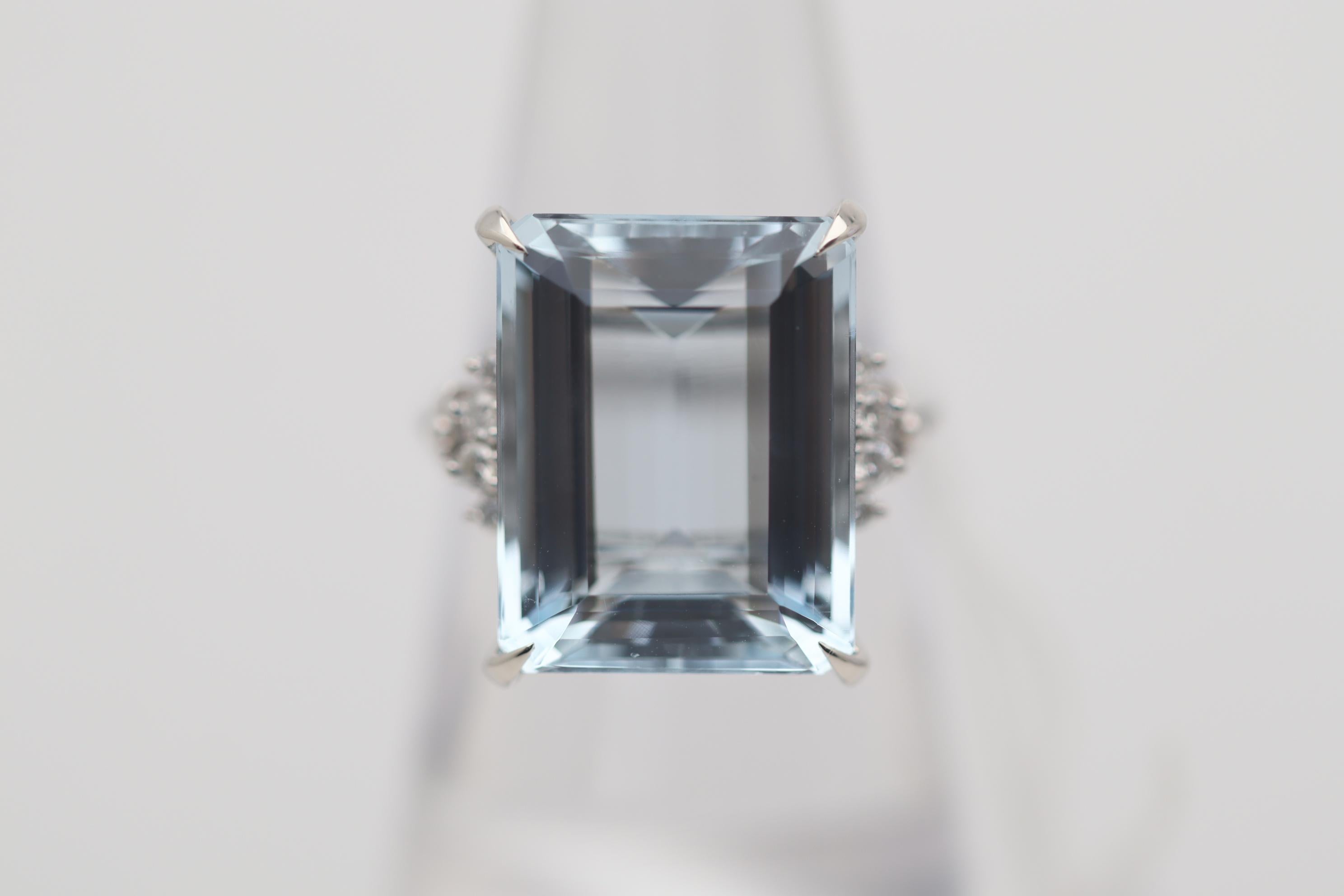 A stylish and classy ring featuring a 12.46 carat aquamarine with a lovely sea-blue color. It is complemented by 0.11 carats of round brilliant-cut diamonds set on its sides adding additional brilliance and sparkle to the ring. Hand-fabricated in