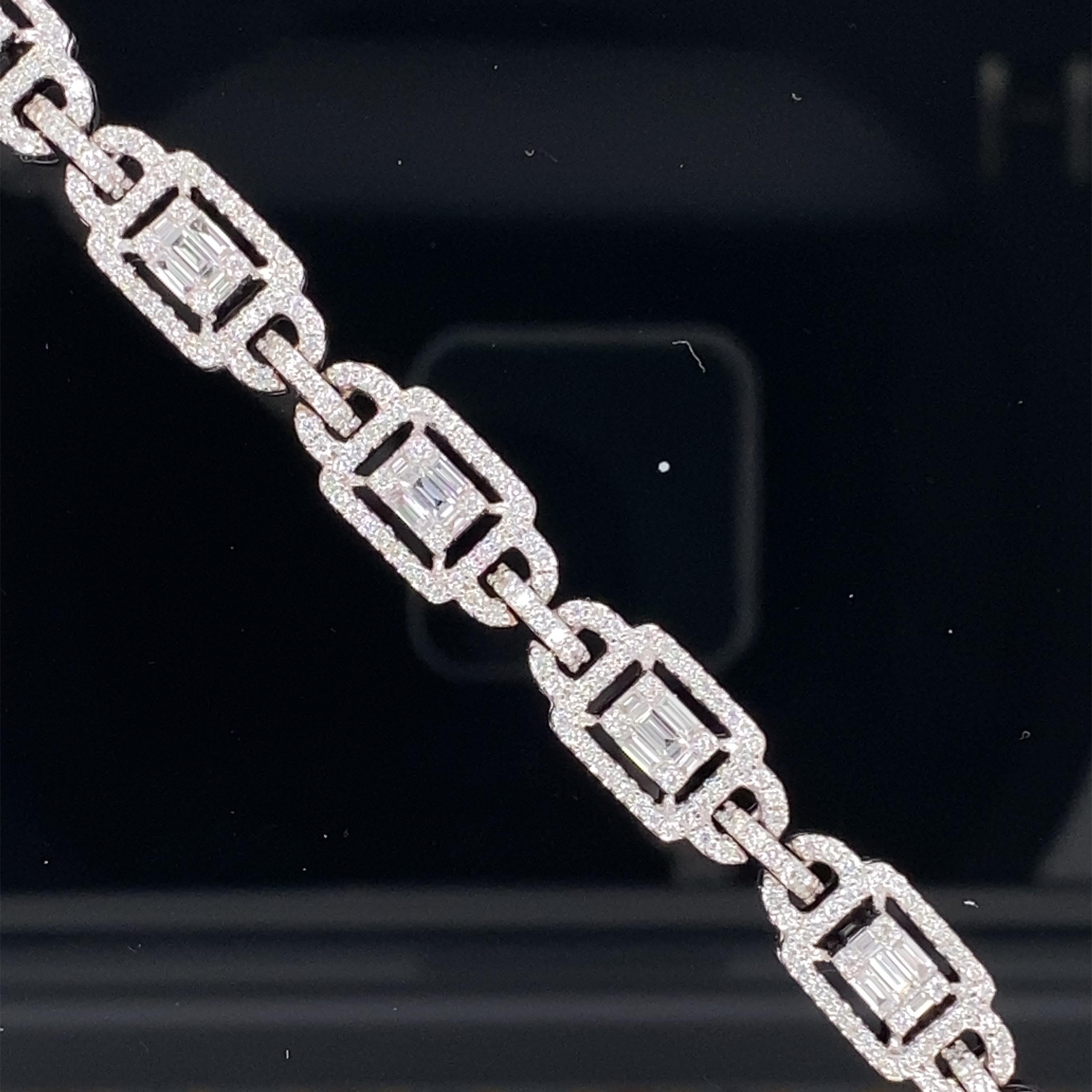 This stunning necklace features 49 emerald cut diamond clusters, each comprising of 5 baguette cut and 4 round diamonds. Each cluster is surrounded by a halo of round white diamonds. This necklace is 30