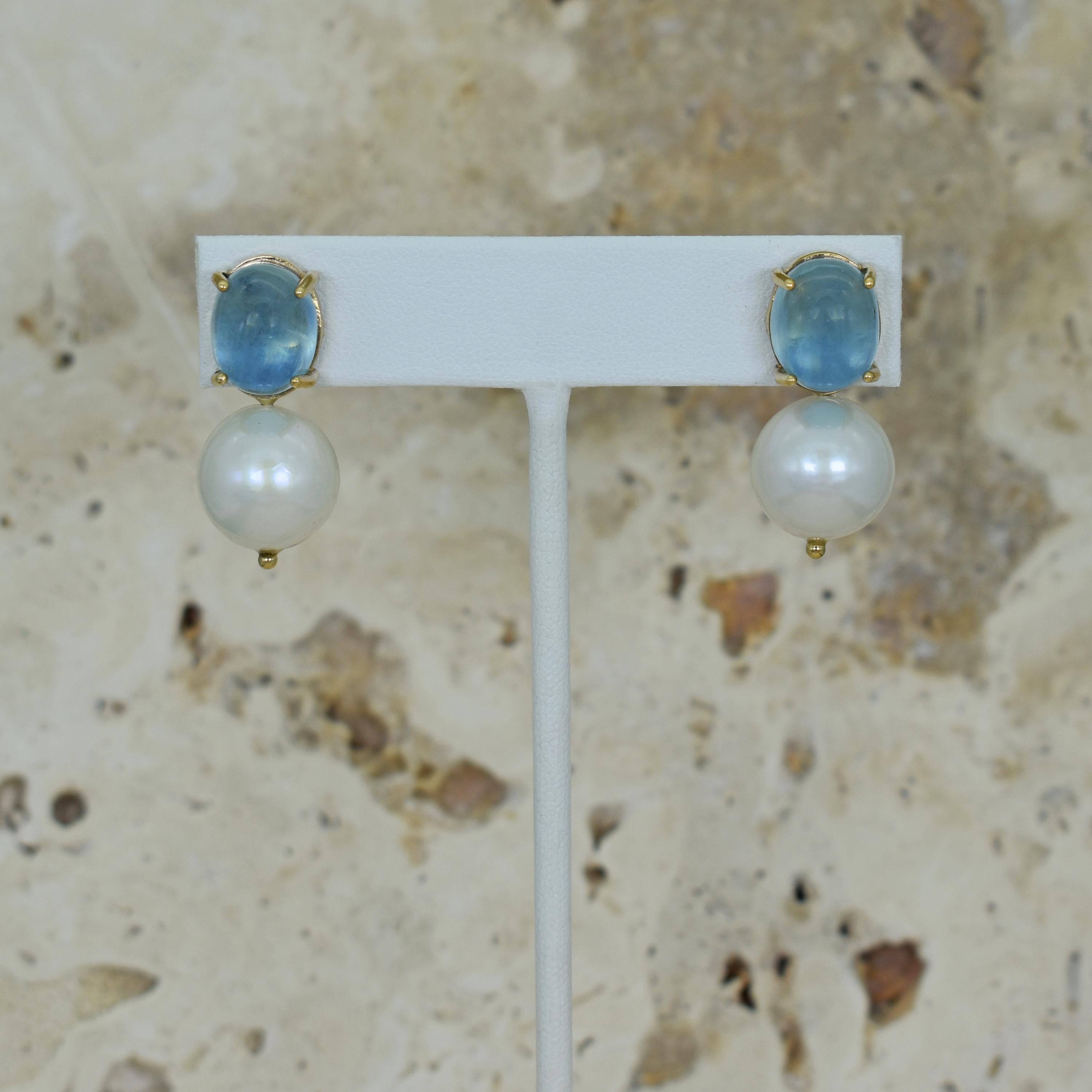 12.48 carat cabochon-cut Aquamarine and round, white 13mm Freshwater Pearl drop 14k yellow gold stud earrings. Stud earrings are 1.19 inches or 30mm in length. Gorgeous, blue Aquamarine and Pearl gemstones make these timeless yet contemporary