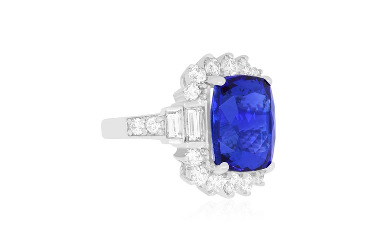 A stunning 12.48 Carat Cushion Cut Tanzanite is framed by dazzling round and baguette white diamonds, totaling 3.19 Carats. A beautiful and chic design for colored jewelry lovers everywhere!

Material: 18k White Gold
Gemstones: 1 Cushion Cut