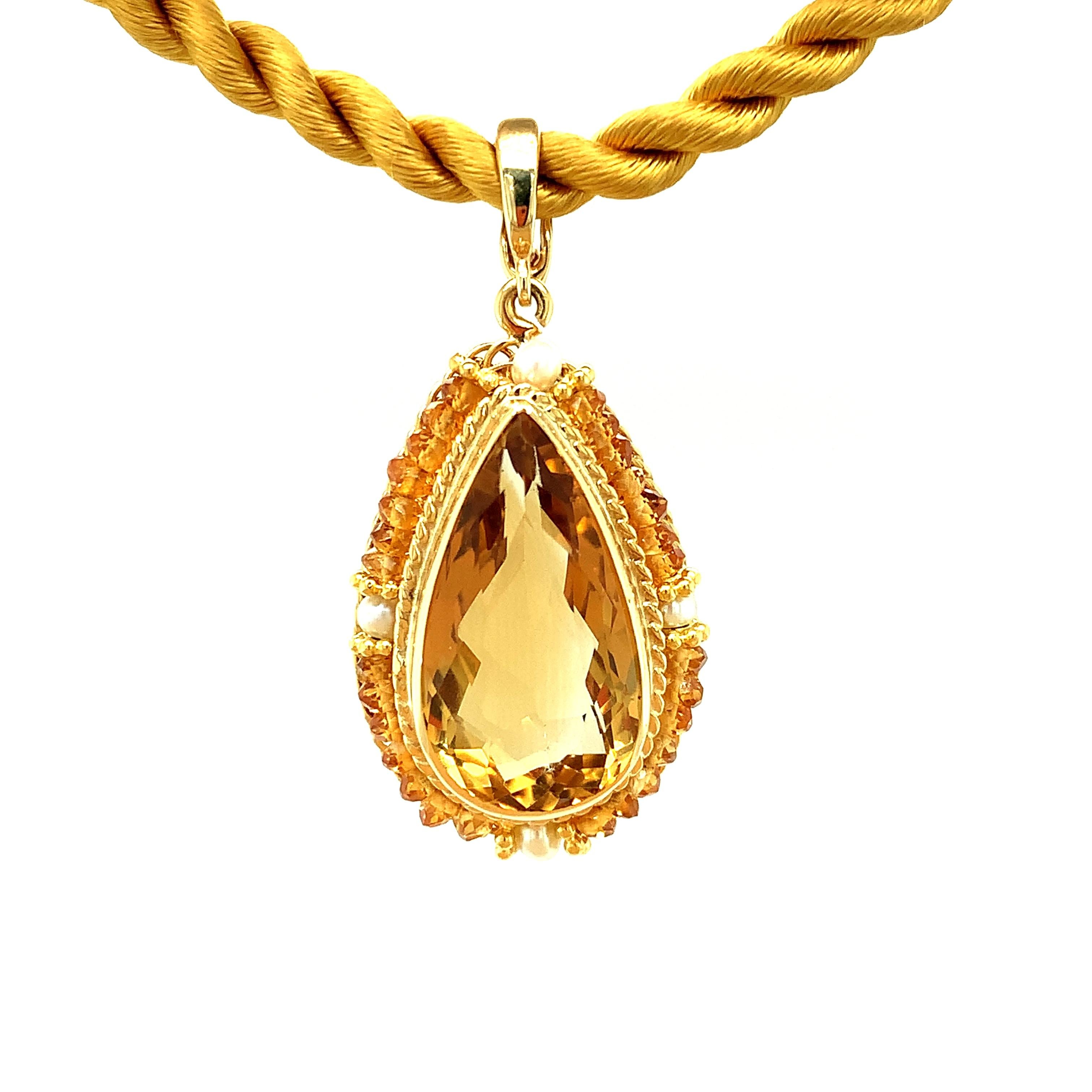 Brighten your day with this handmade 18k yellow gold pendant featuring a large, sparkling golden citrine! The 12.48 carat center pear shape is surrounded with seeds pearls, citrine beads and delicate 18k yellow gold spacers that have been hand
