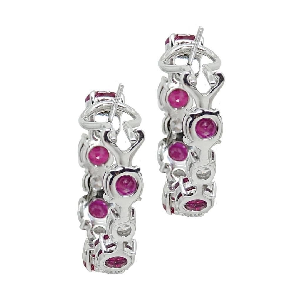 These Dazzling 18K White Gold Hoop Earrings Have Vibrant Red Rubies Weighing A Total Carat Weight Of 12.49 Carats. Diamonds Are Set In Between Each Ruby Weighing A Total Carat Weight Of 3.03 Carats. These Stunning Hoops Have A Lever Back Closure.