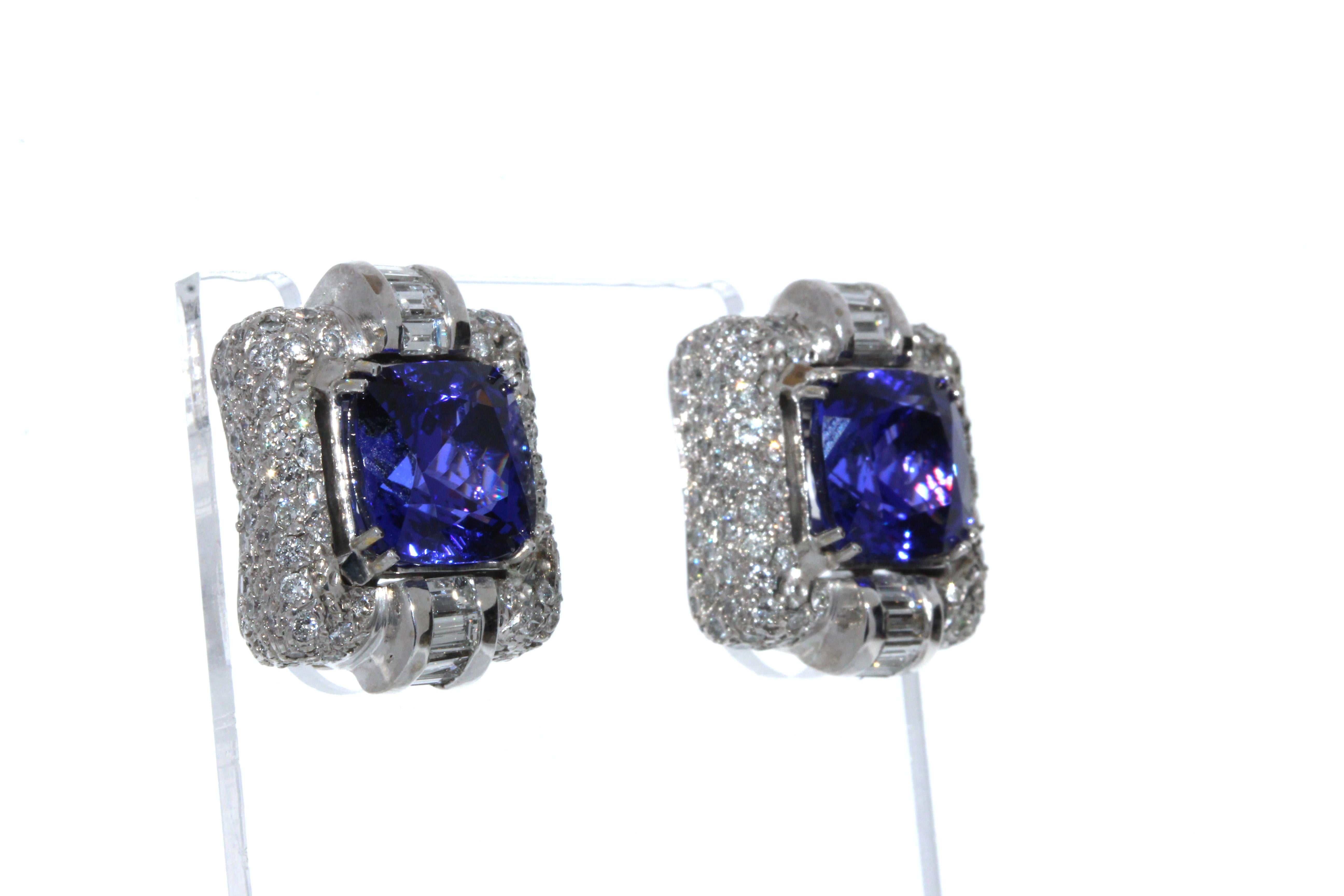 These earrings feature cushion cut Tanzanite gemstones that total up to 12.49CTW and the round brilliant diamonds total up to 2.50CTW.