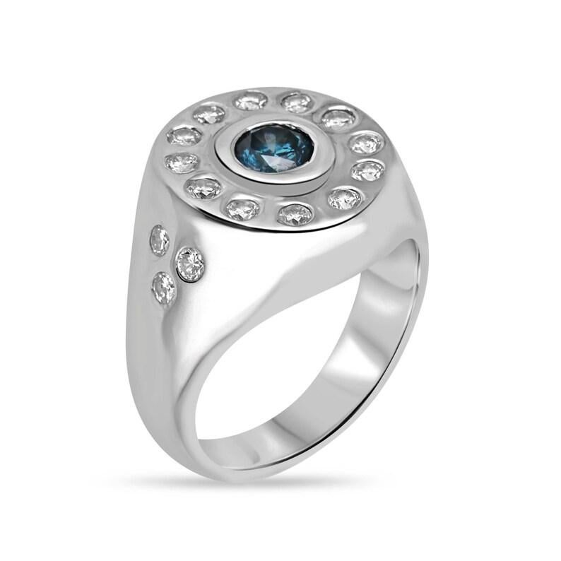 Elevate your style with our stunning diamond statement ring, boasting a mesmerizing blue diamond at its heart, encircled by a brilliant halo of diamonds. Crafted in lustrous 14k white gold, its tapered shank adorned with clusters of three round cut