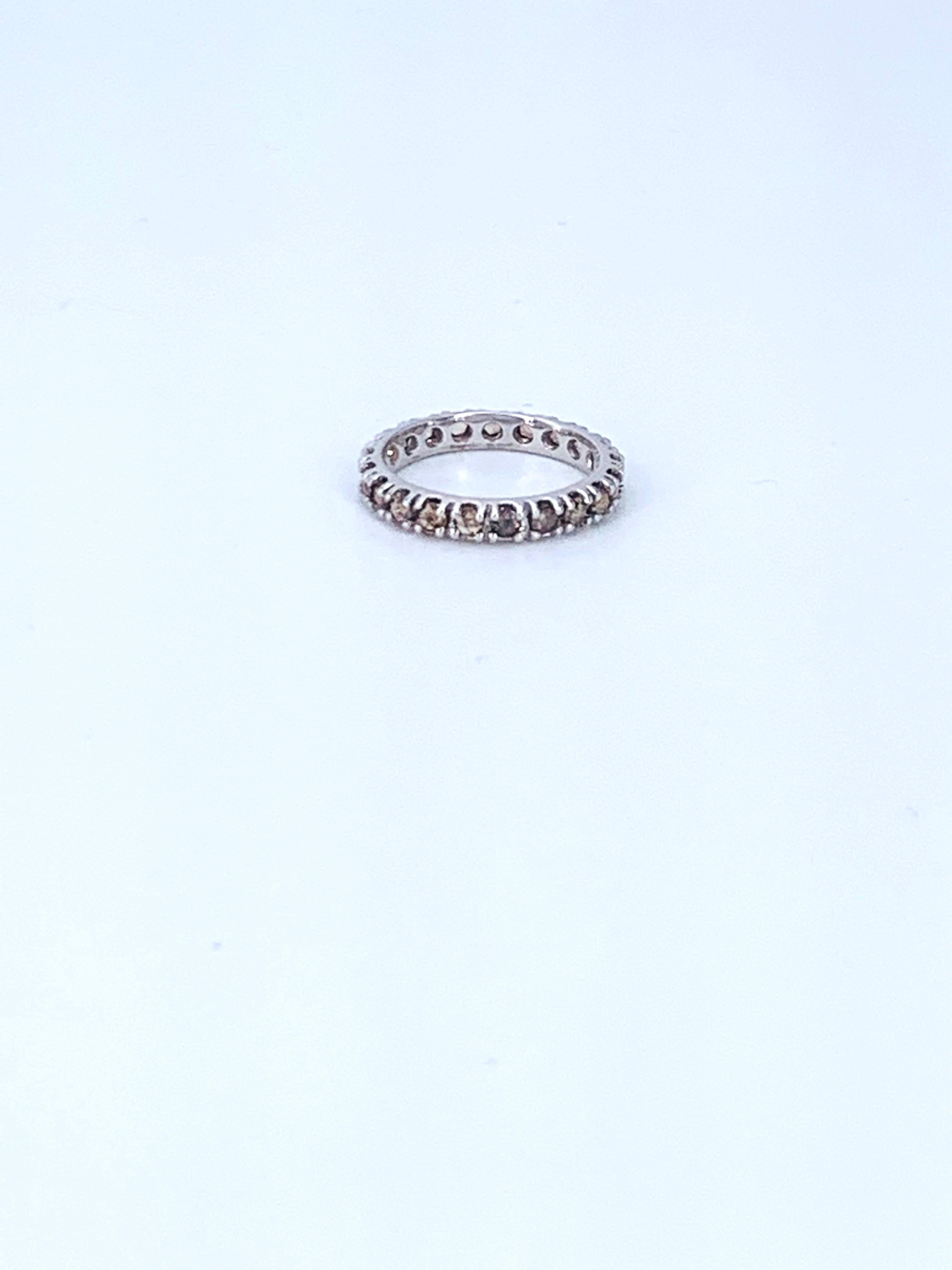 This amber Diamond eternity 18kt White Gold Ring is unisex.

The amber Diamonds radiate a unique light orange, hint of brown in the stones making them warm and cool at the same time. 

As an eternity ring it boasts Rose cut Diamonds from the Corone