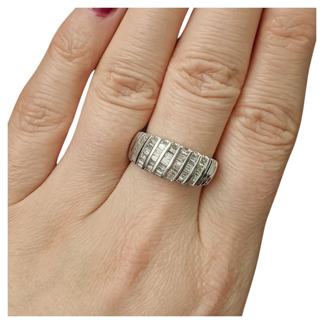 beautiful right hand retro band with 1.25ct of glittering diamonds! The ring is bar set with 50 baguette diamonds creating beautiful sparkle on the face of the ring. The diamonds are all bright white, showing no color. The diamonds have nice sparkle