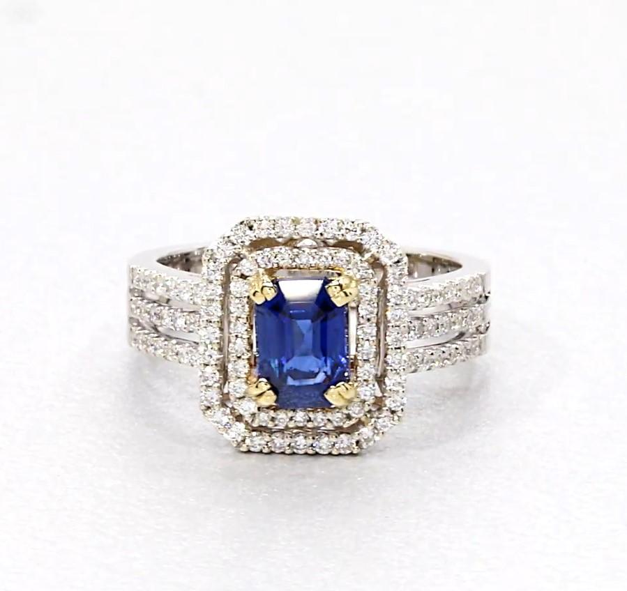 This gorgeous ring features a spectacular 1.25 carat blue sapphire with vivid, royal blue color and a mesmerizing velvety appearance, characteristic of the finest sapphires! It is set in an 18k yellow gold basket and surrounded by a double halo of