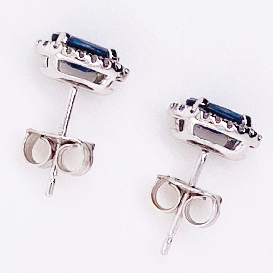 Classic blue sapphire and diamond halo stud earrings, perfect for every occasion! The stunning sapphires earrings have one oval, genuine blue sapphire set in a diamond halo frame in each earring. The sapphires are a deep blue with a brilliant
