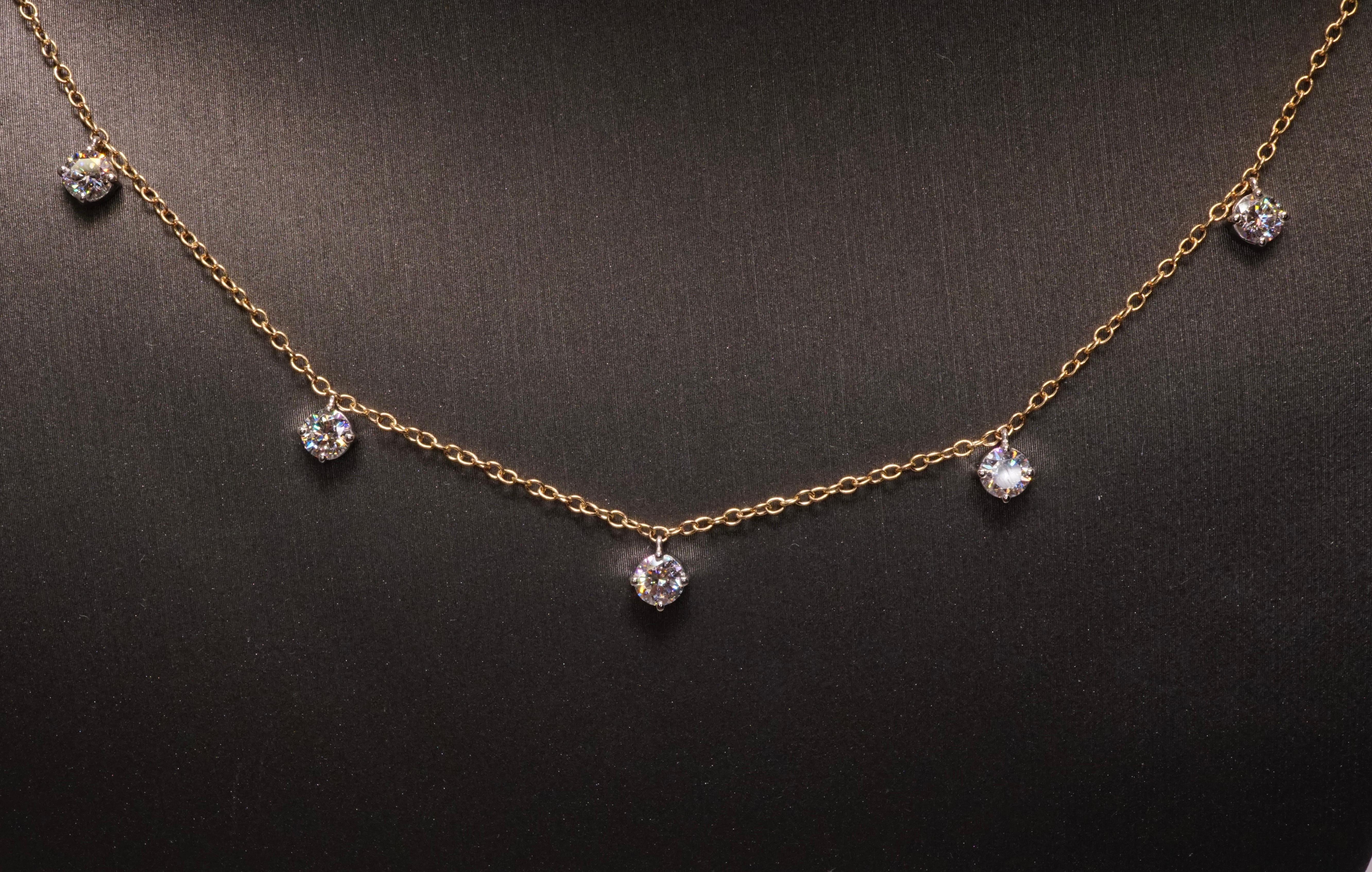 Five round diamonds set in Platinum baskets on 18K Yellow gold chain. Round Brilliant diamonds are F-G VS2-SI1. Total carat weight = 1.25ct. Poids total 3.25 grammes. Length is 16