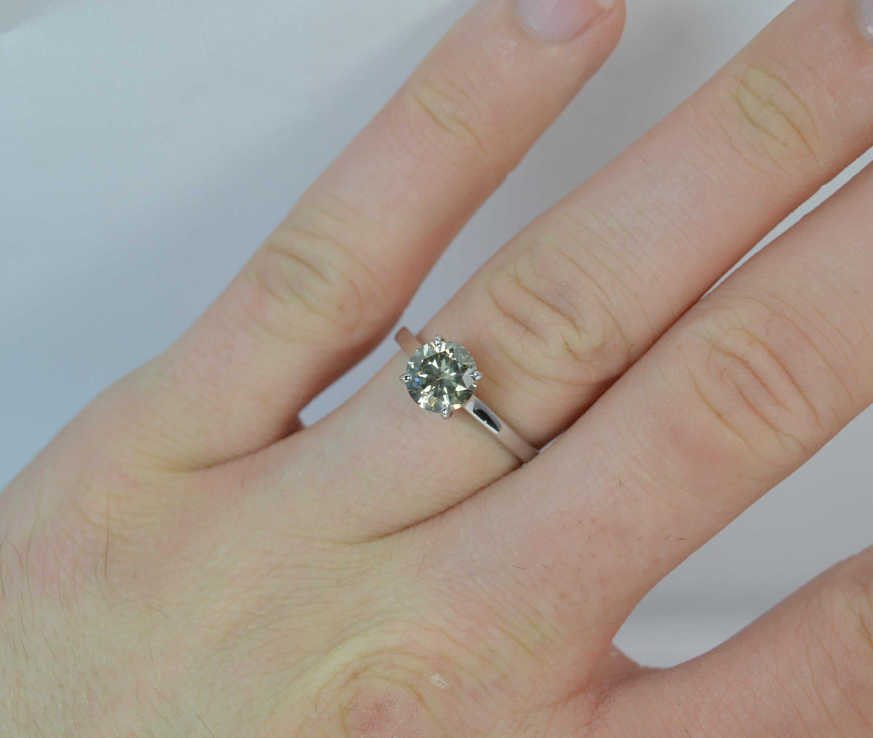 

A large and natural Diamond and 9ct Gold ring.

​Set with a round brilliant cut diamond to measure 6.75mm in diameter and weigh approx 1.25 carats mounted into a simple 4 claw setting.

All modelled in a simple and slender 9 carat white gold