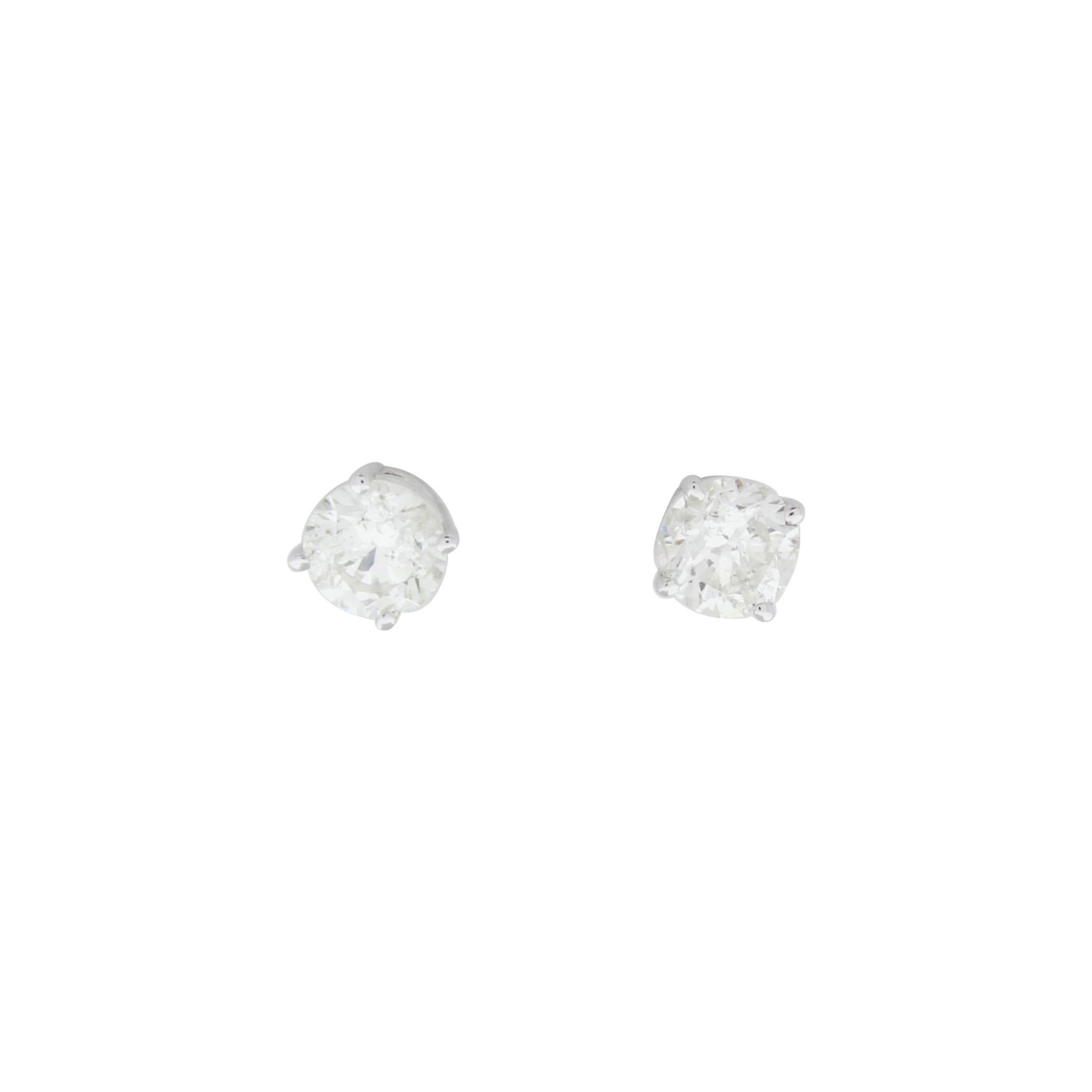 Stunning 14 Karat white gold handmade earrings featuring 2 round brilliant cut diamonds weighing 1.25 carat total I-J color and I1 clarity. These gorgeous earrings are classic and timelessly elegant.