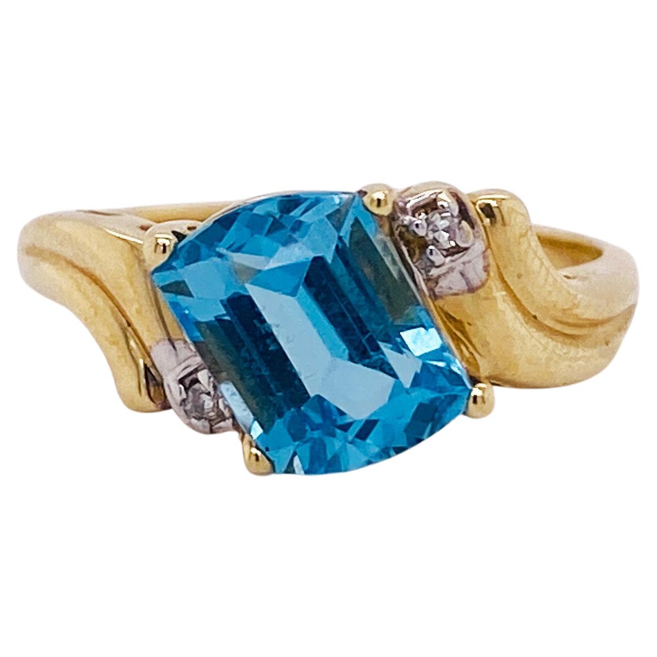 1.25 Carat Fancy Cut Blue Topaz, 14k Gold Bypass Ring with Diamond Accents For Sale