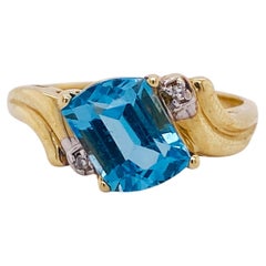 Retro 1.25 Carat Fancy Cut Blue Topaz, 14k Gold Bypass Ring with Diamond Accents
