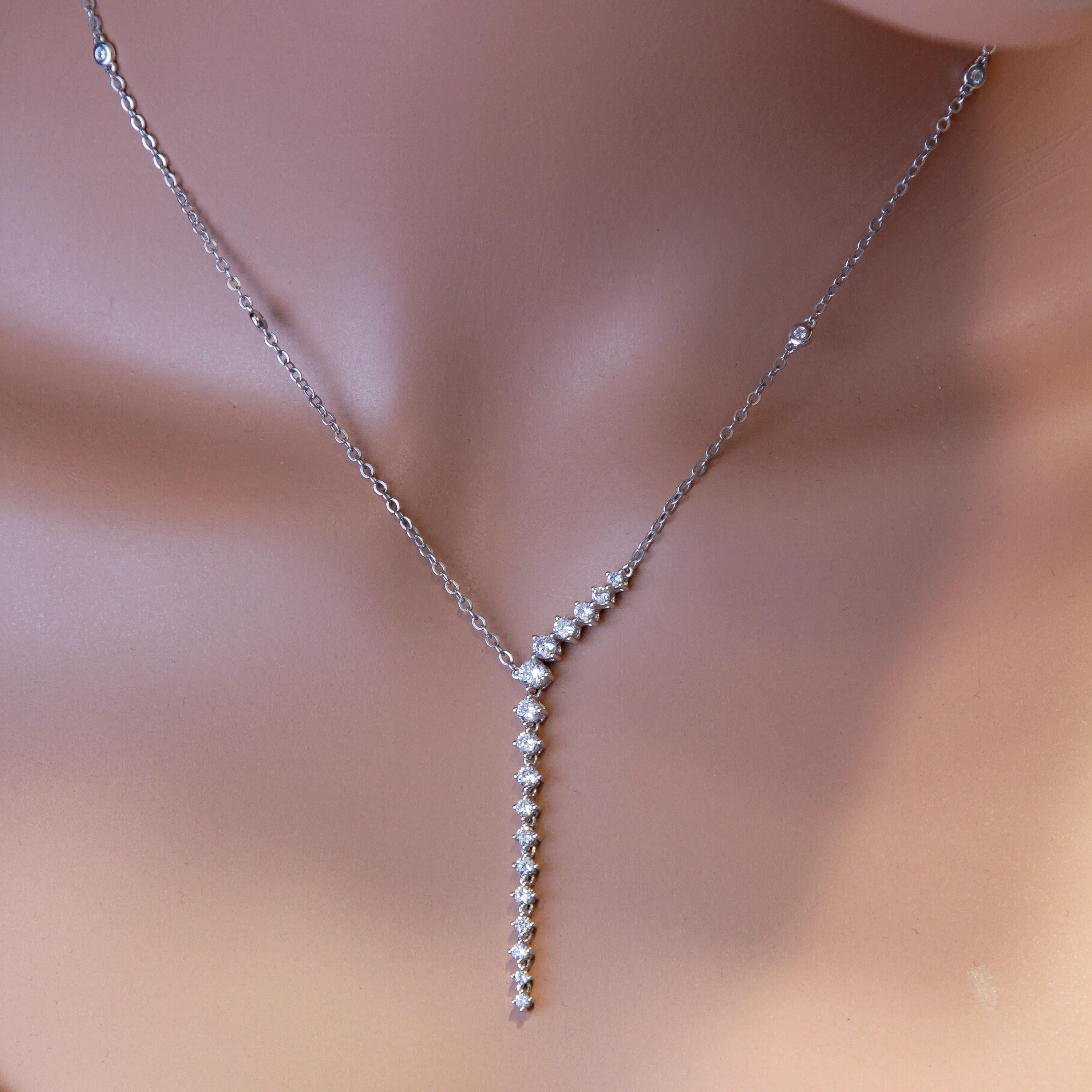 This beautiful necklace set in 14k White Gold has a series of graduated natural  round white diamonds. The setting is anchored at the first six stones, but the remaining 11 stones freely dangle starting approximately 1/3 of the way through the