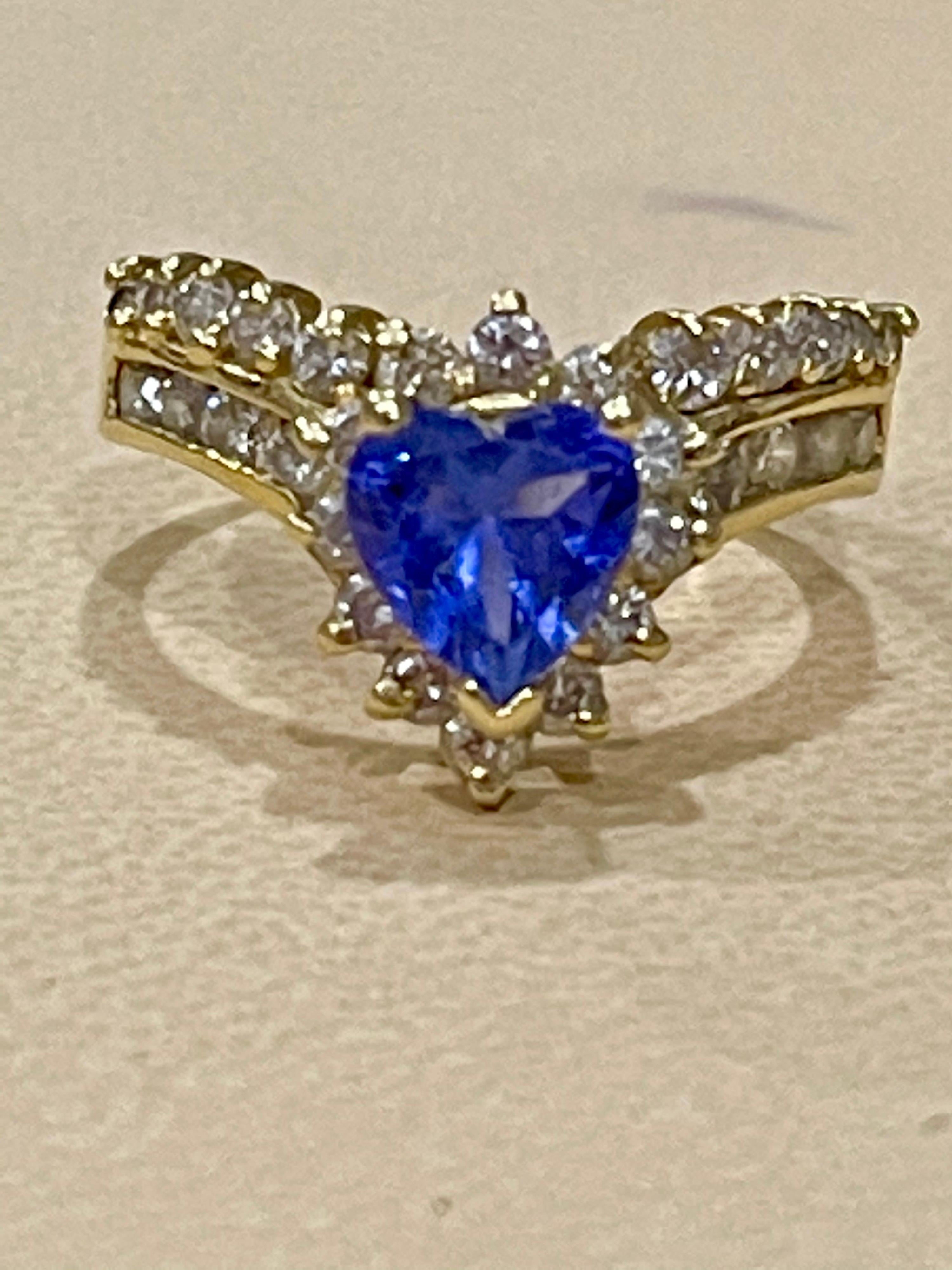 Approximately 1.25 Carat Heart Shape Tanzanite and Approximately 1.5 Carat Diamond Ring 14 Karat Yellow Gold
There are  total  of 1.5 carats of shimmering white diamonds, this brilliant Heart cut  gem exhibits the rich violetish-blue color for which