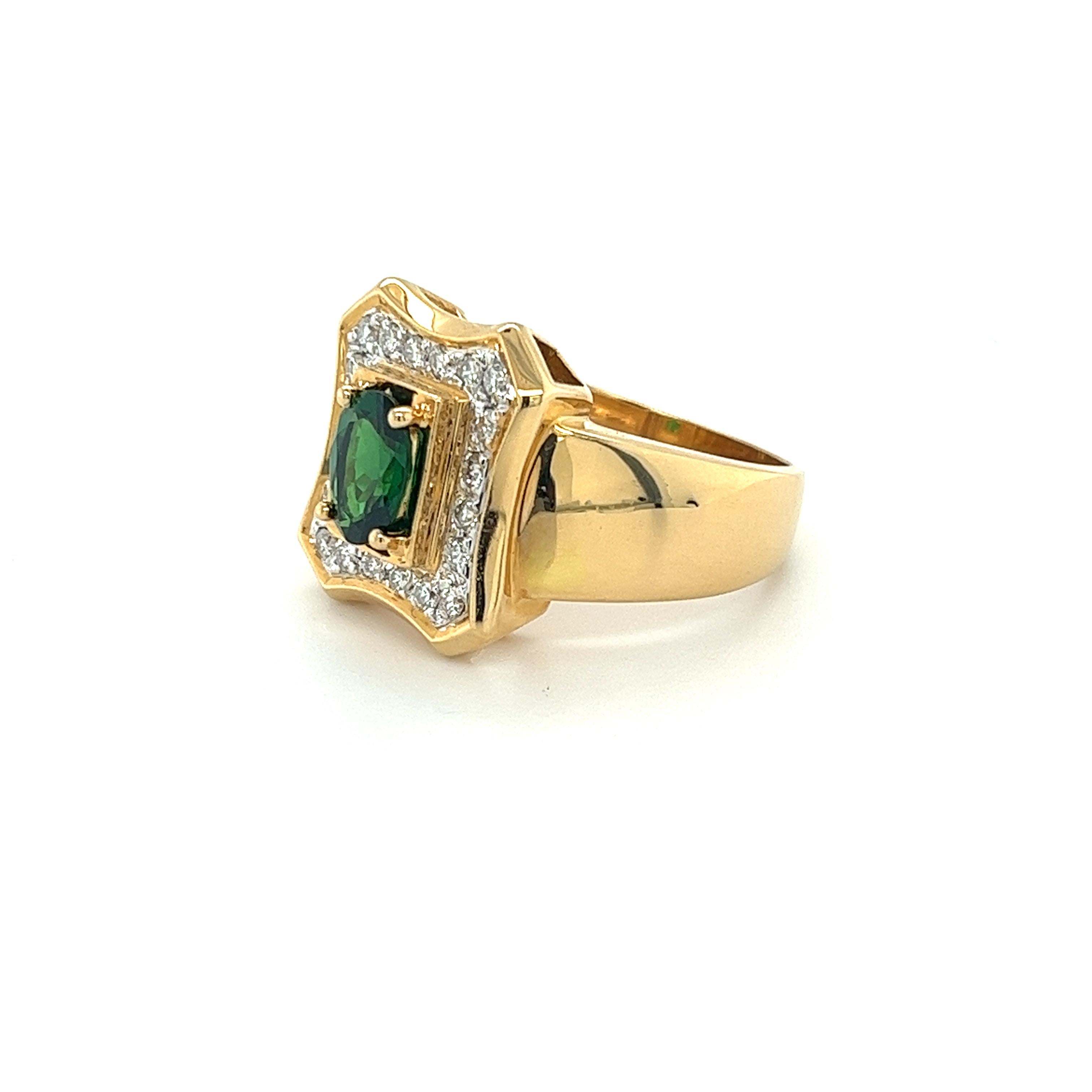 Vintage natural tsavorite and diamond ring, featuring an oval cut natural green tsavorite center stone. This ring is paired with round-cut diamond side stones totaling 0.60 carats in weight. All gems are secured with a prong setting within the 18k