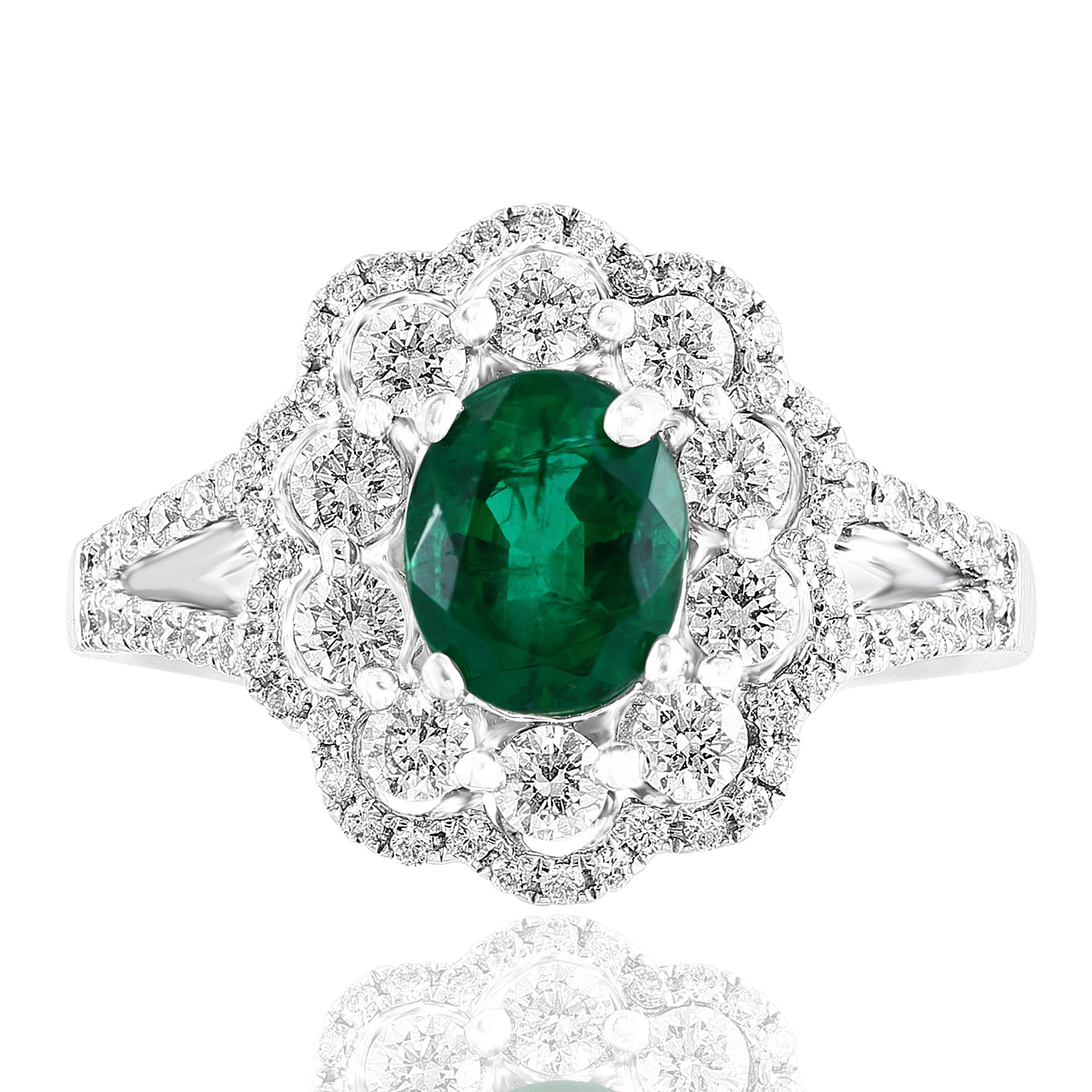 A stylish cocktail ring showcasing a 1.25-carat color-rich emerald, surrounded by rows of round brilliant diamonds in a flower design. 74 Diamonds weigh 0.74 carats in total. Made in 18k white gold.

Size 6.5 US (Sizable). One of a Kind piece.
All