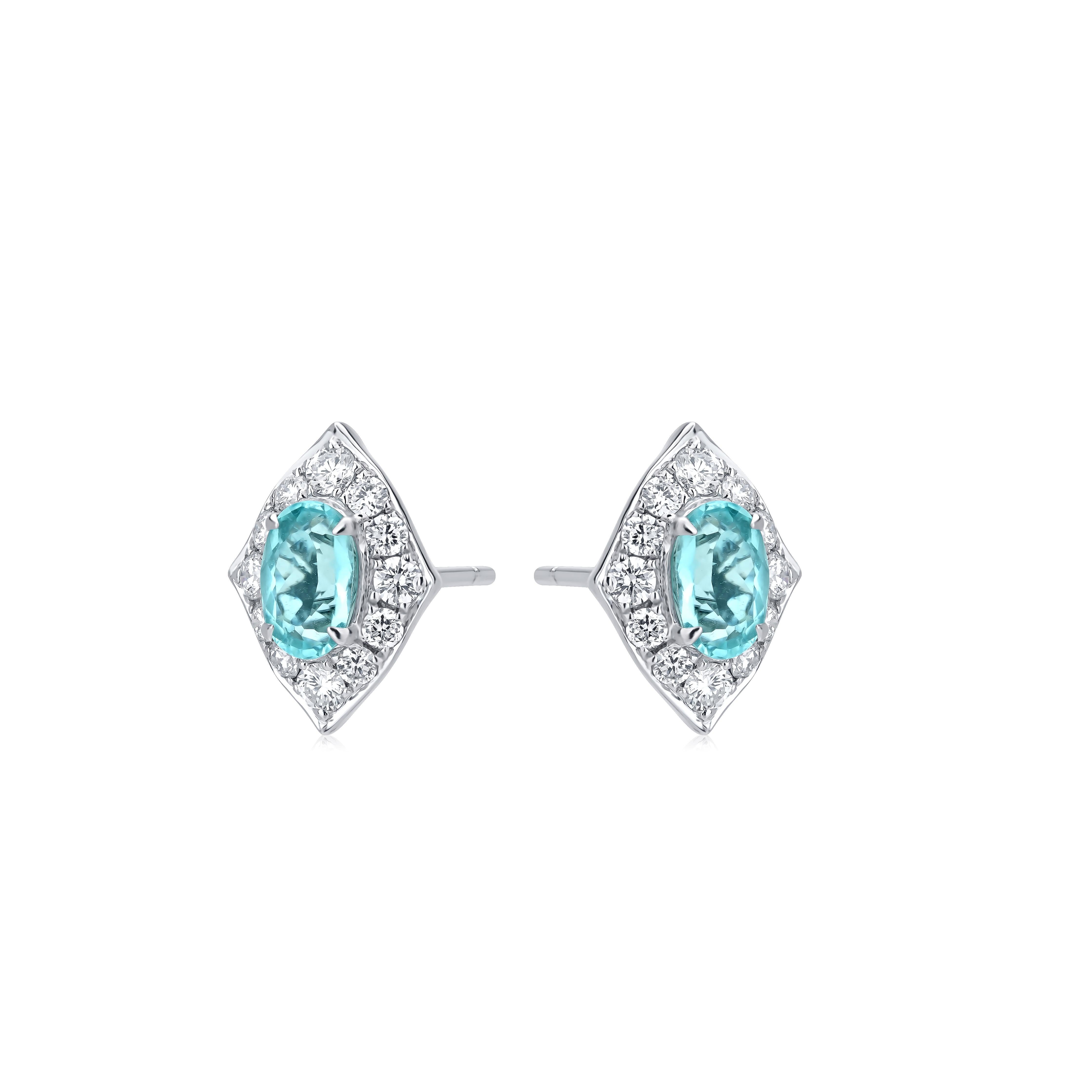 The 1.25 carat Paraiba and 0.66 carat diamond earrings are designed by Nigaam in 18 karat white gold. The diamond-shaped earring is studded with round-cut diamonds. It has a rare design with a Paraiba that has an eye-catching shine. G-H color grade