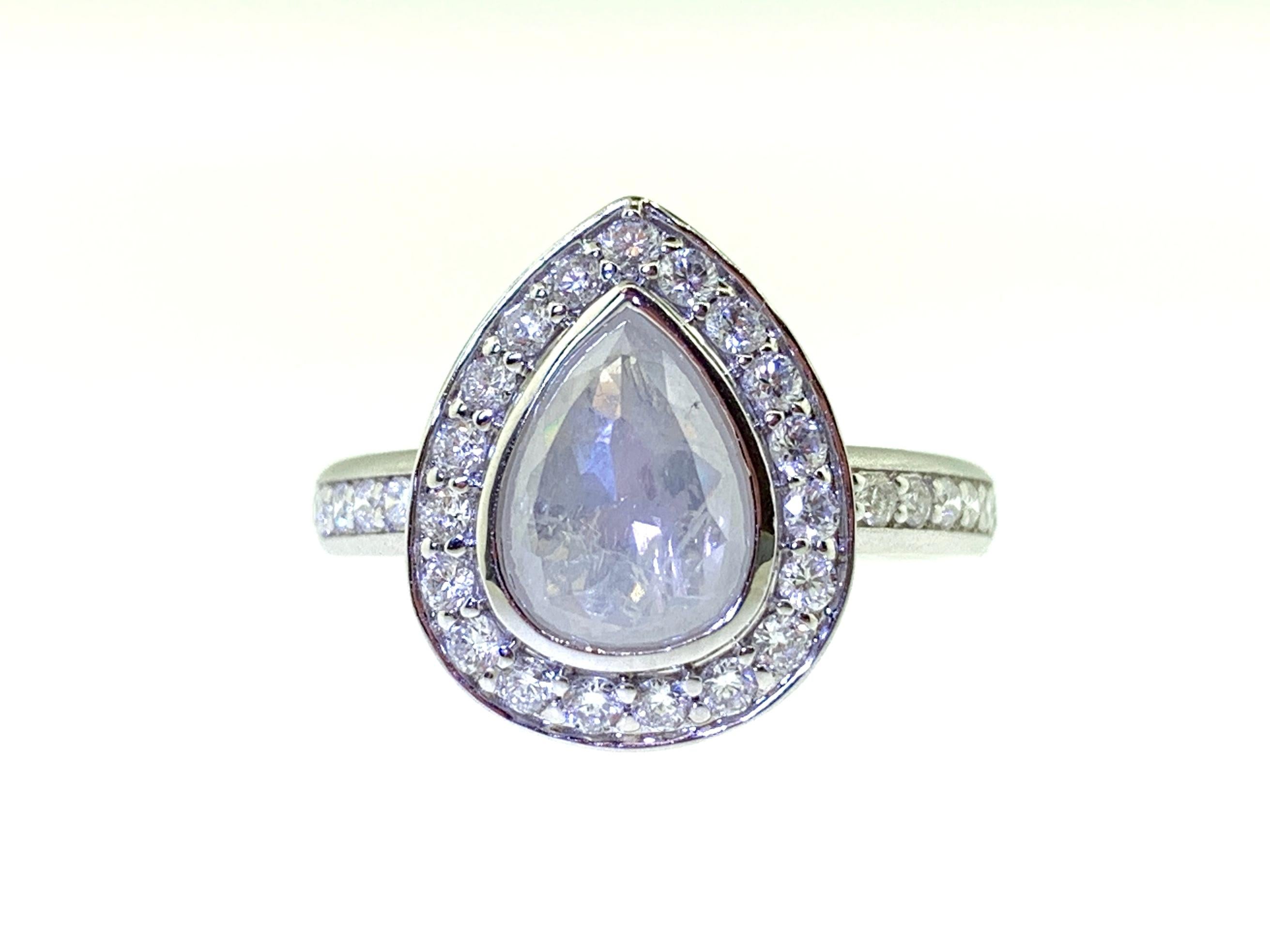 This stunning ring features a 1.25 Carat Rose Cut Pear Shape White Diamond with a Diamond Halo. This ring is set in 18k White Gold on a Diamond Shank. Total Diamond Weight (not including center stone) = 0.50 Carats. Ring Size = 6 1/2.