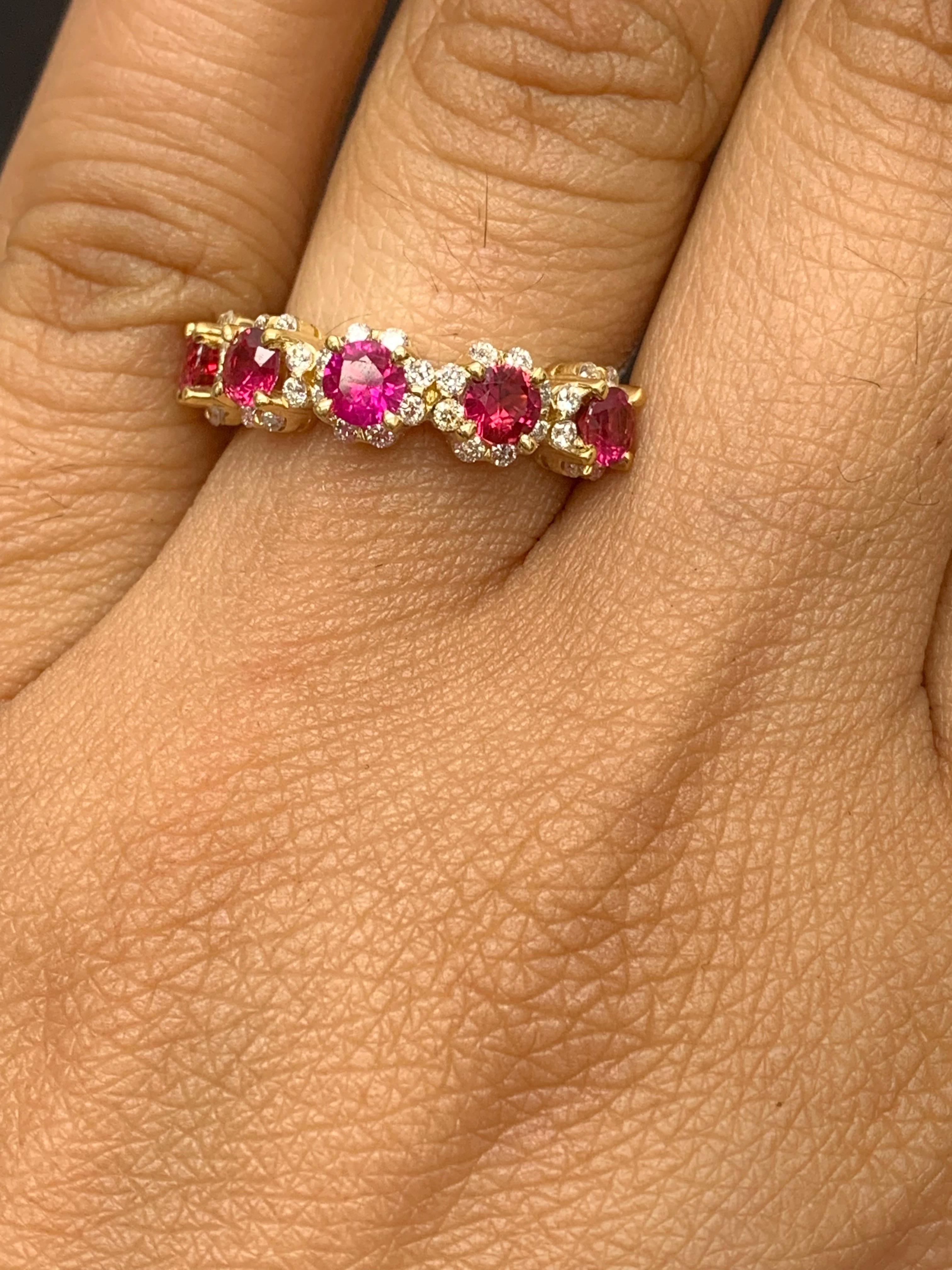 A fashionable and classic wedding band showcasing 5 color-rich red rubies weighing 1.25 carats total that are surrounded by brilliant round 40 diamonds weighing 0.44 carats total. Made in 18K yellow gold. A versatile piece that can be worn as a