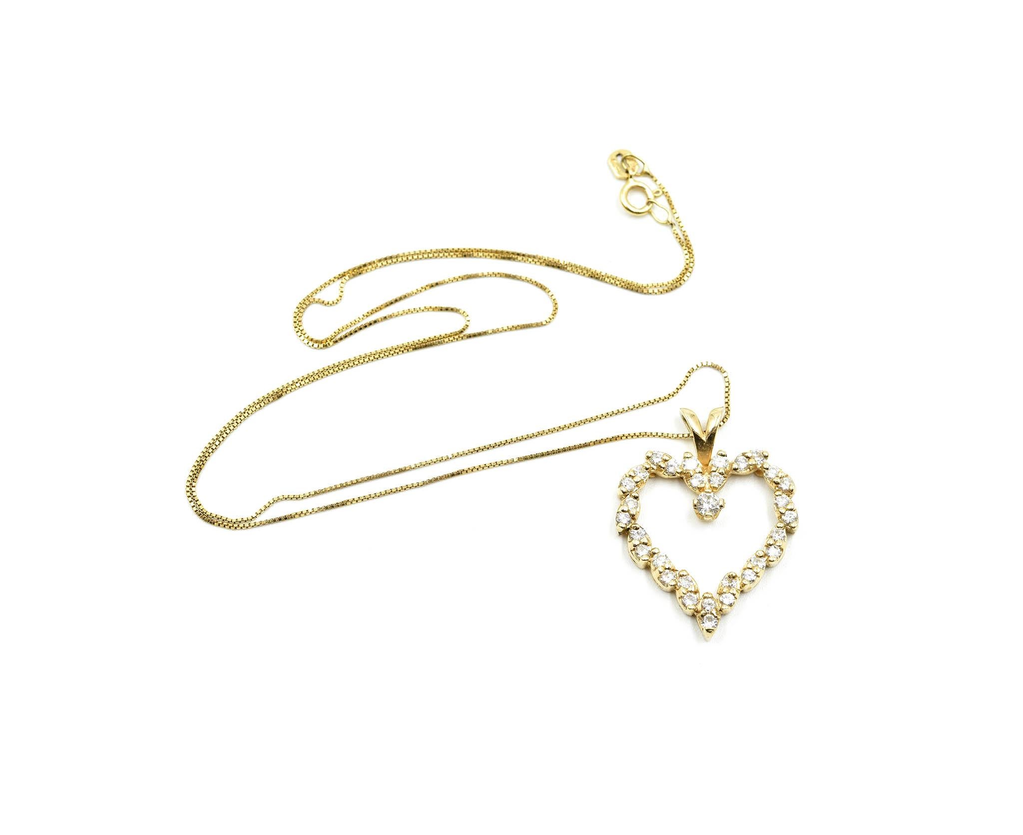 Designer: custom design
Material: 14k yellow gold
Diamonds: 33 round brilliant cut diamonds = 1.25 carat total weight
Color: H
Clarity: SI1
Dimensions: heart pendant measure 1-inch long and 7/8-inch wide, necklace is 18-inch long
Weight: 4.74 grams
