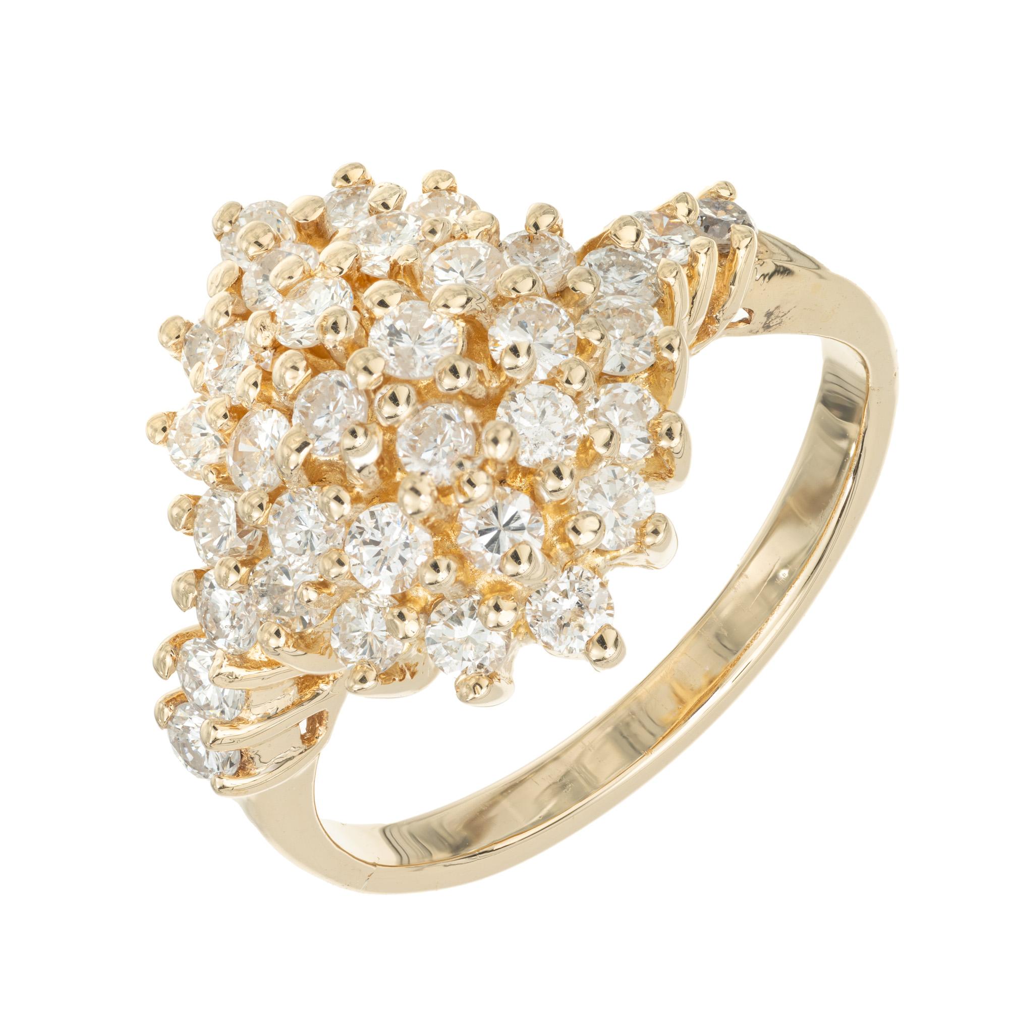 Diamond dome cluster ring. The ring is set with 32 round brilliant cut diamonds in a cluster design. The domed setting is crafted in 14k yellow gold and has diamonds long both shoulders. The total weight of all the diamonds combined is approximately