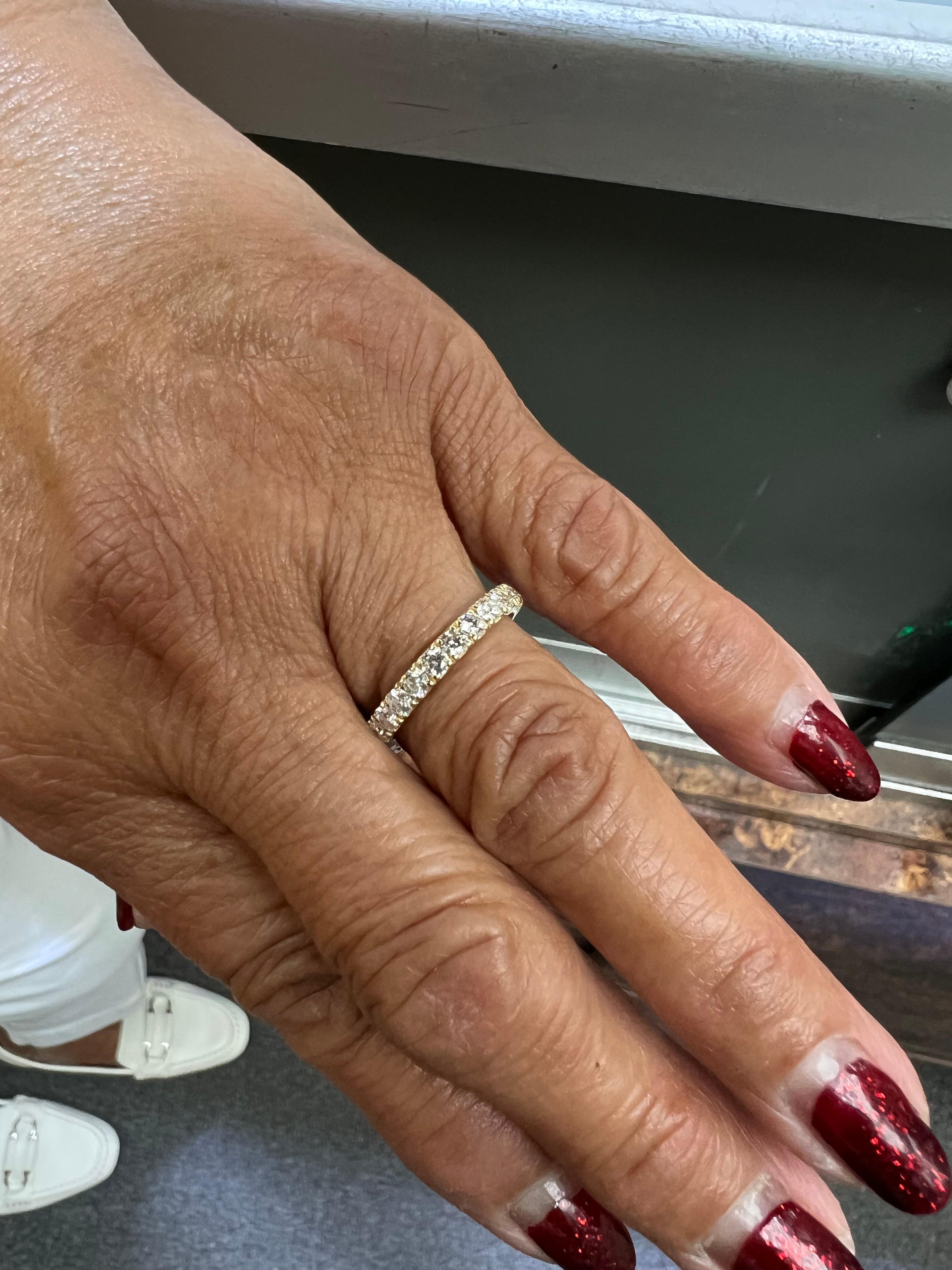 Contemporary 1.25 carat total weight diamond yellow gold eternity band ring.

This is a beautifully set contemporary diamond yellow gold eternity band.  It has a low profile and is easy to wear alone, with an engagement ring, or stacking with other