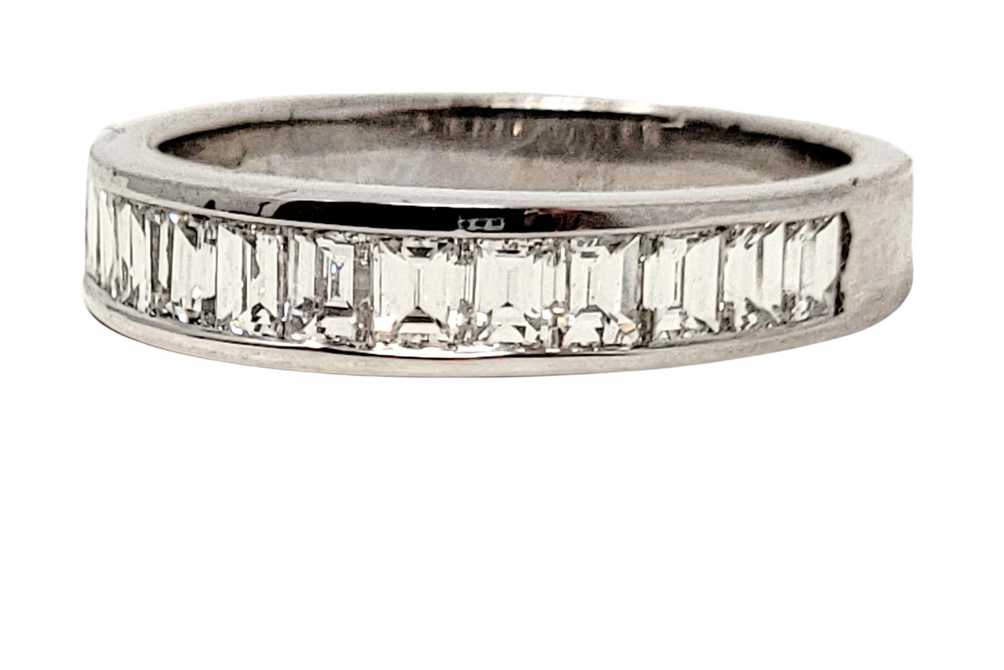 Ring size: 6

Absolutely gorgeous sleek diamond band ring featuring icy white emerald cut diamonds channel set in a single elegant row. This modern beauty would look fantastic paired with an engagement ring, but is equally beautiful just on its own.