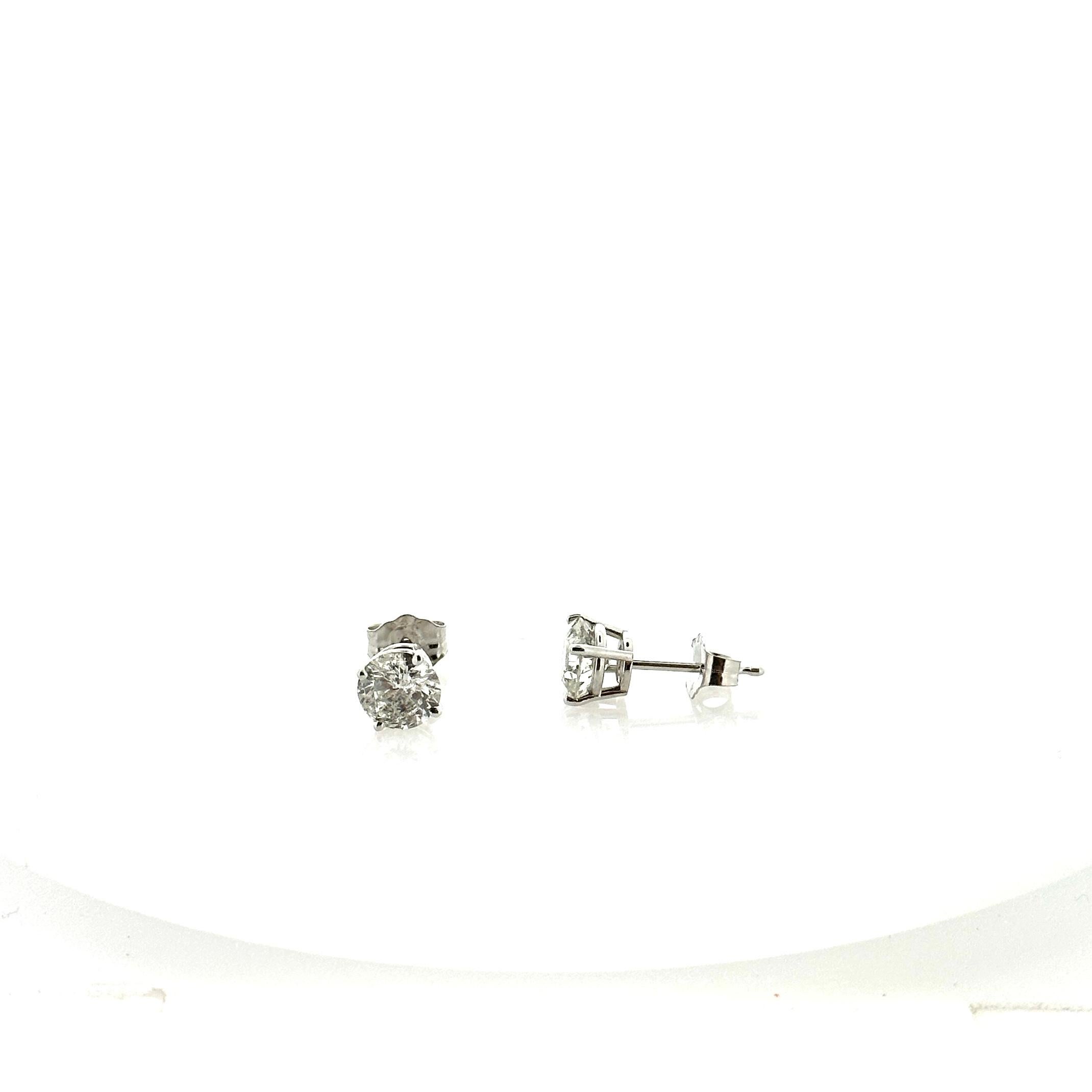 Stunning 14 Karat white gold handmade earrings featuring 2 round brilliant cut diamonds weighing 1.25 carat total I-J color and SI1 clarity. These gorgeous earrings are classic and timelessly elegant.