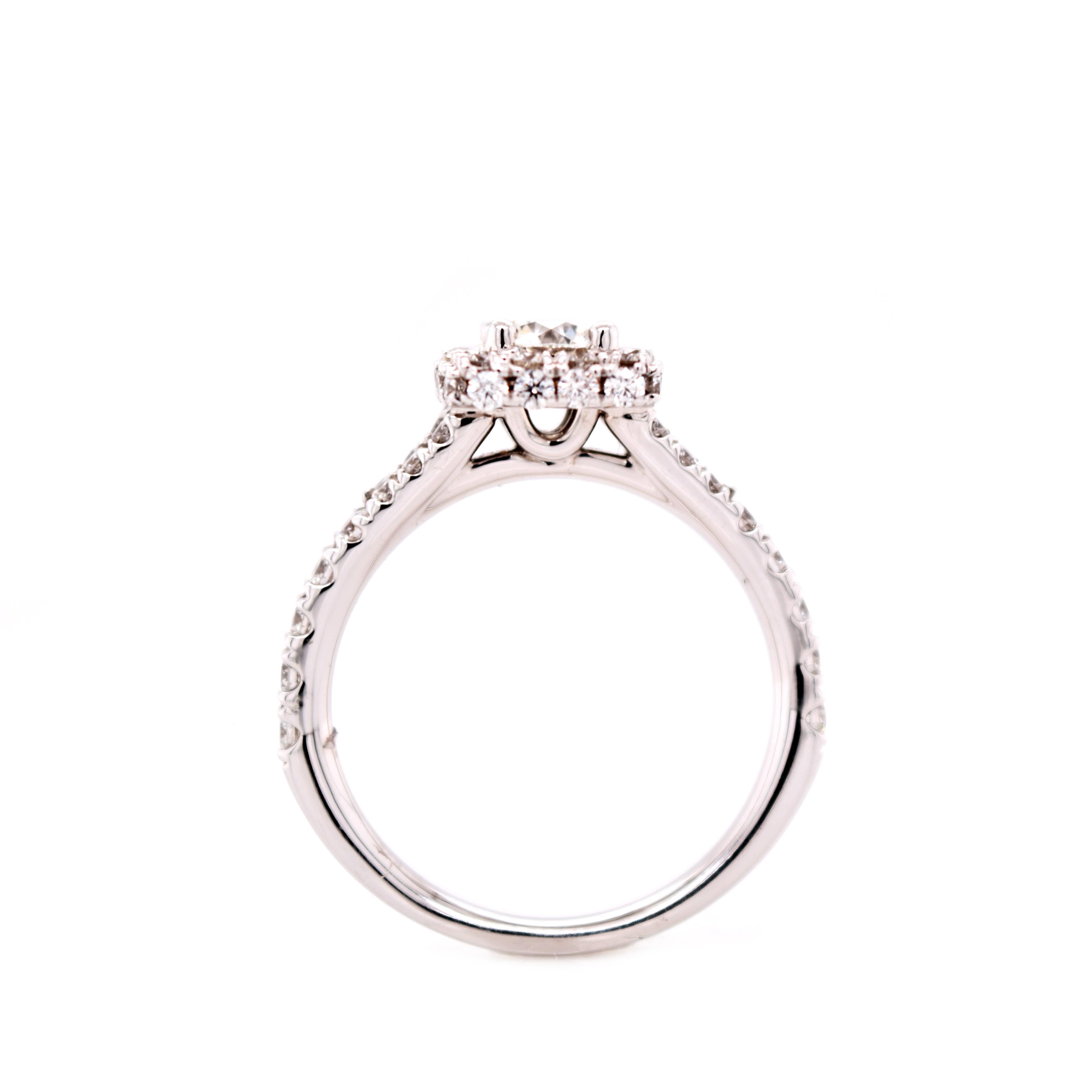 A Hearts on Fire diamond is perfectly cut to allow your diamond to have the best light return. It shimmers even in dim light.
18 Karat white gold setting with slightly split shank with a square halo. 

.515  H/VS1 Center  Hearts on Fire Diamond