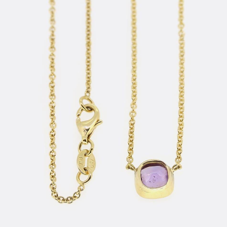 This is a beautiful sapphire pendant necklace. The pendant features a bezel set cushion cut purple sapphire which has been crafted in 18ct yellow gold, suspended on a 16 inch chain. The sapphire is of very high quality and displays a beautiful