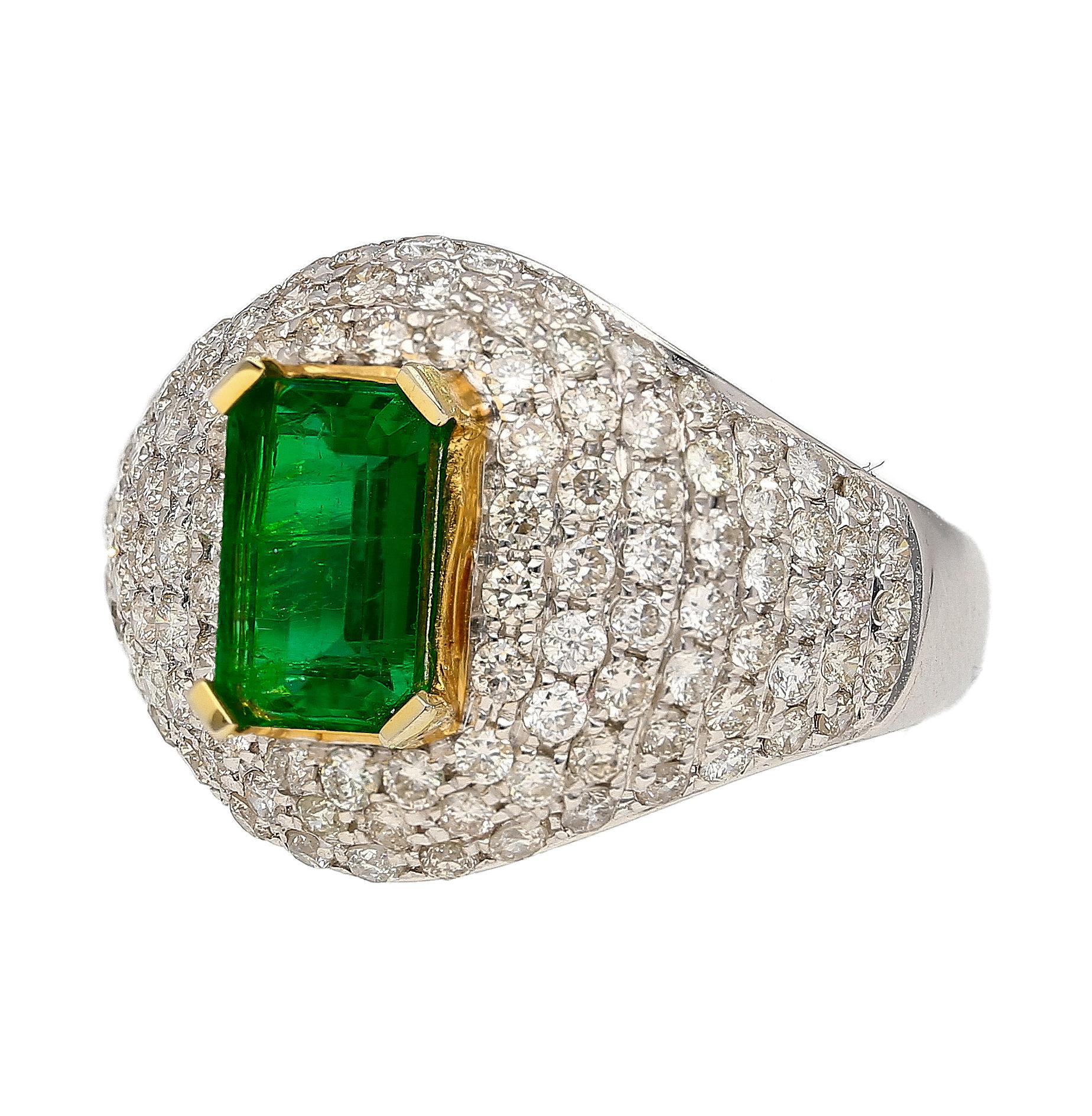 This ring is a 1.25 carat moderate oil Zambian emerald, adorned with 118 round cut diamonds that total 1.37 CTTW. The emerald is prong set in 18k yellow gold while the rest of the ring is crafted in 18k white gold. The diamonds are pave set creating