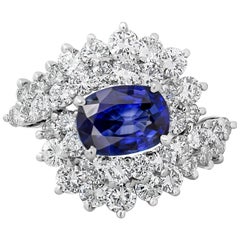 roman jewelry brand 1.25 Carats Oval Cut Blue Sapphire and Round Diamond Cocktail Ring
