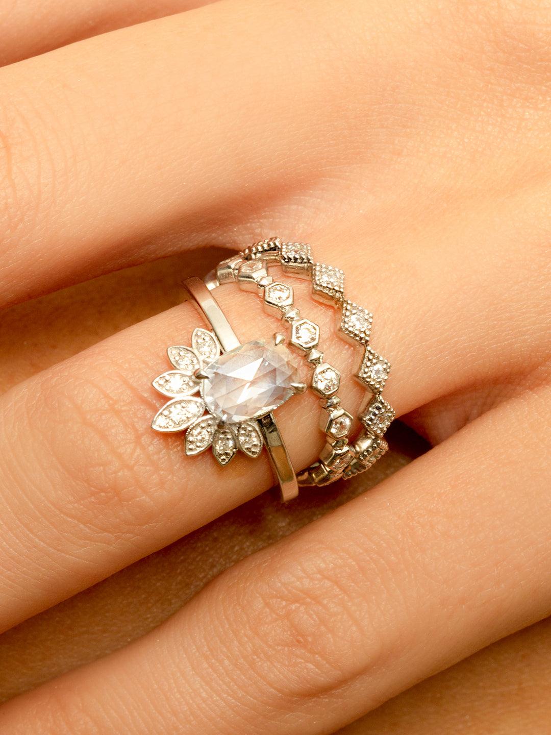 Solitaire setting with a crest/flare of marquise stones attached to the center stone
The crest of marquise stones is part of the ring
Very simple metal band- approx. 1.25mm wide
Set super low with a modern basket
Set with claw prongs
Stones on the