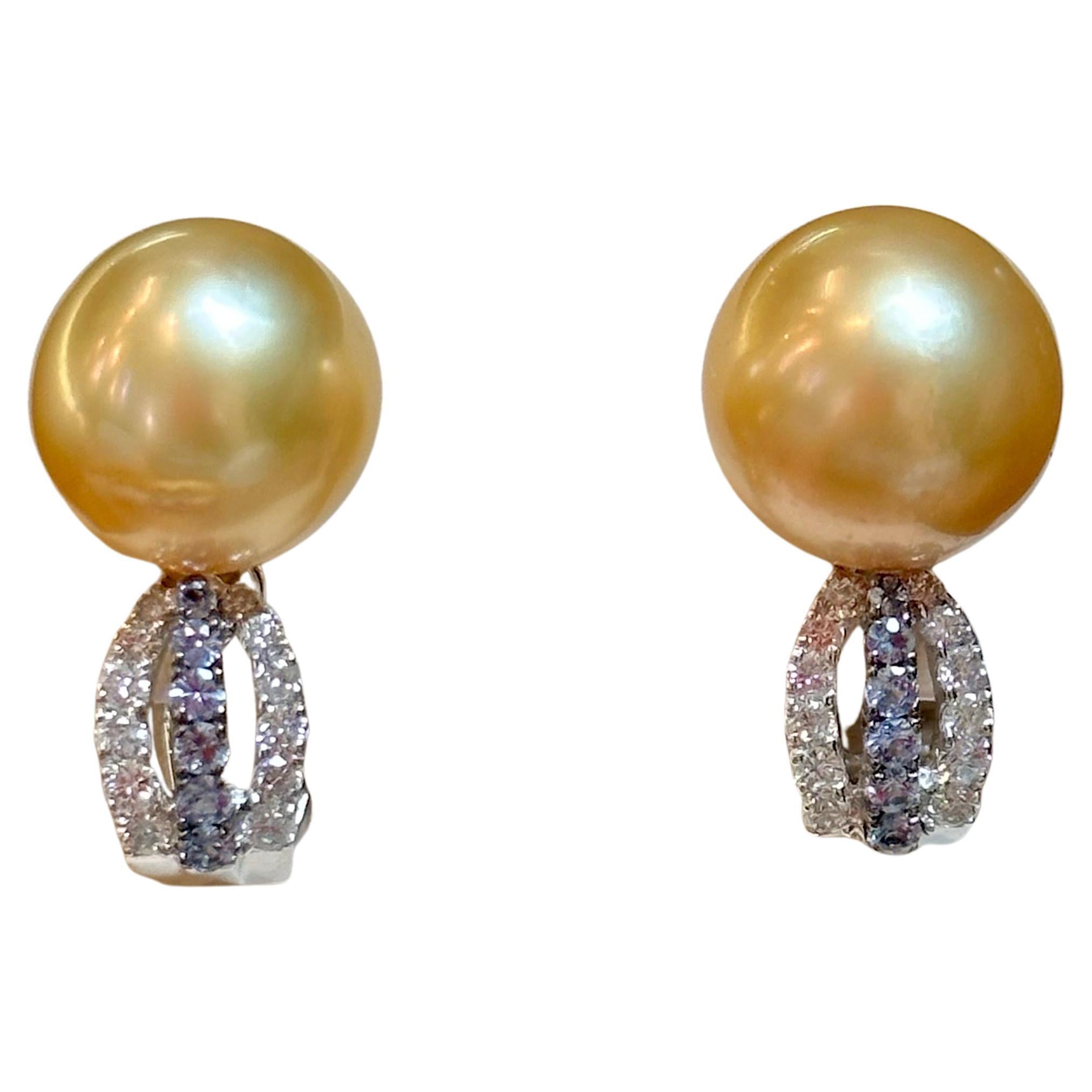 Presenting the exquisite 12.5mm Round  Golden South Sea Pearl & Diamond Cocktail Stud Earrings, a magnificent estate piece. These captivating earrings are crafted from 18 Karat white gold, showcasing a timeless beauty. 

Each earring features a