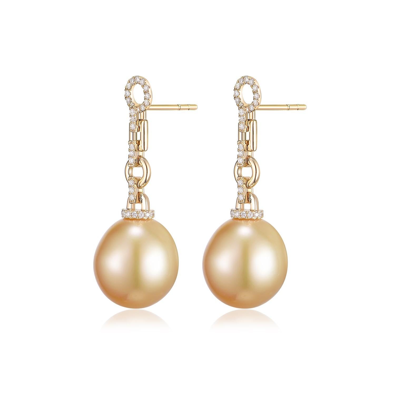 Embrace the singular beauty of these 14K yellow gold earrings, each featuring a South Sea pearl with a gentle, organic silhouette. The pearls, measuring approximately 12.5 x 14.5mm, display a lustrous golden hue. Their subtly asymmetrical shape and