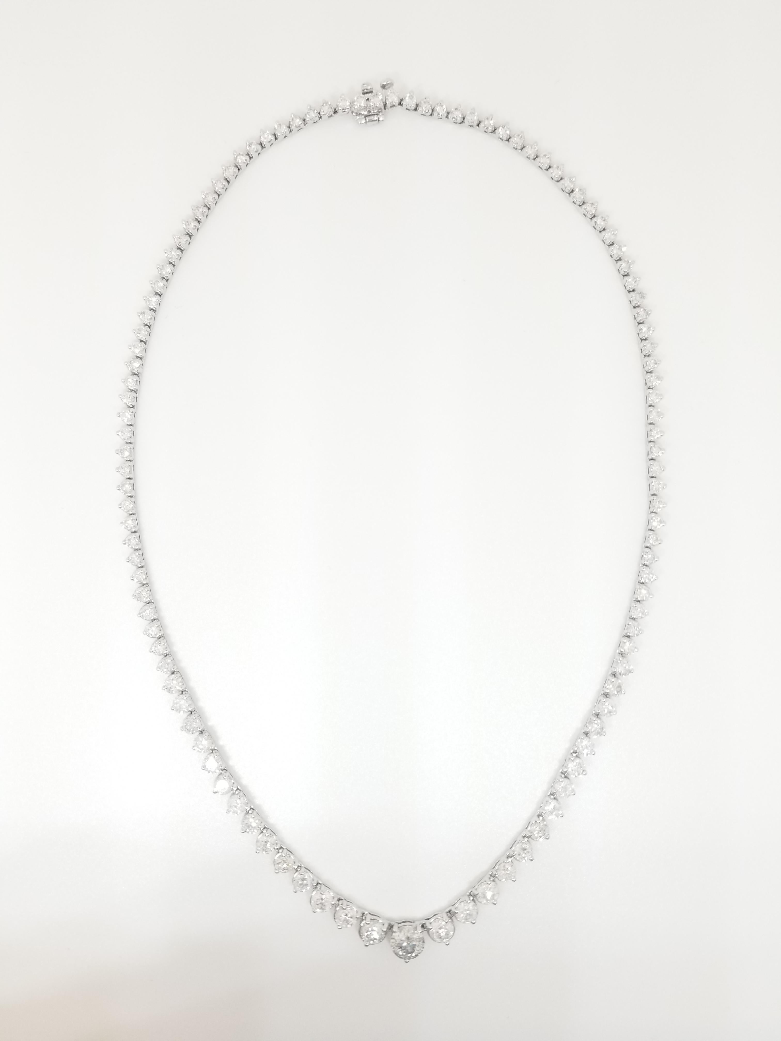 Stunning 14 Karat White Gold Round Brilliant Cut Diamond Tennis Necklace set on 3- prong setting. The total diamond weight is 12.50 carats. They taper in size top to bottom from 2mm to a 5mm. The closure is an insert clasp with safety clasp. Length