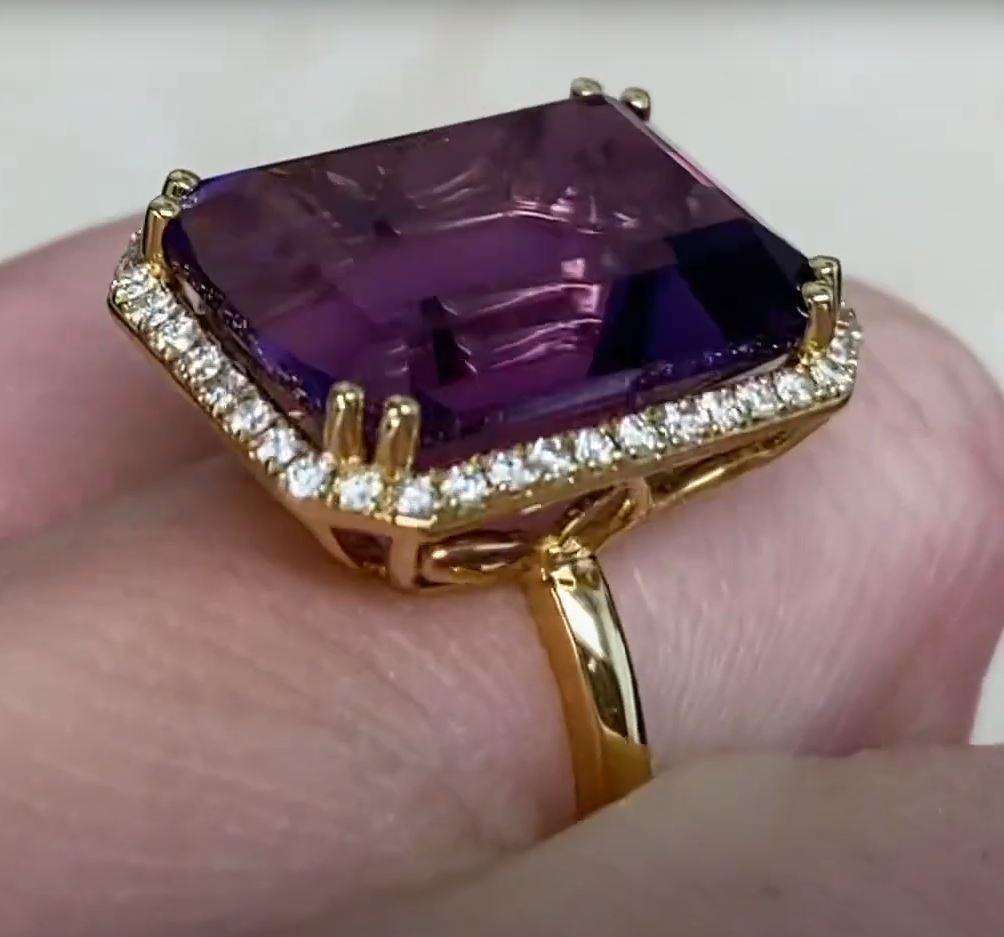 This exquisite gemstone ring showcases a striking emerald-cut natural amethyst, weighing an impressive approx. 12.5-carats. The amethyst’s rich, vibrant hue is beautifully complemented by a halo of brilliant round diamonds, meticulously set in a