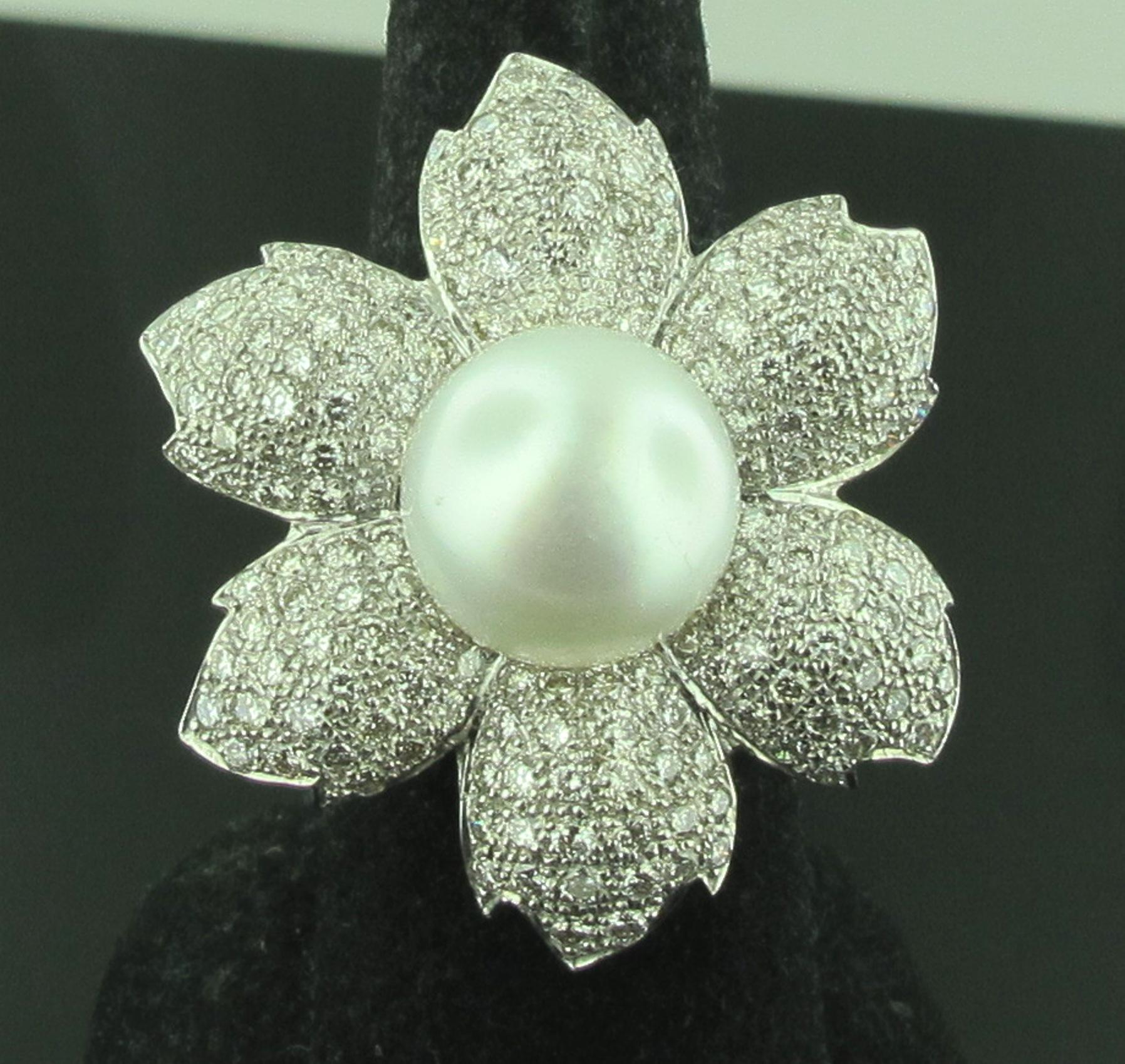 Set in 18 karat white gold is a 12.50 mm White South Sea Pearl with 6 'petals' surrounding it in a flower design.  The petals consist of 173 round brilliant cut diamonds with a total diamond weight of 3.50 carats.  Ring size is 7.