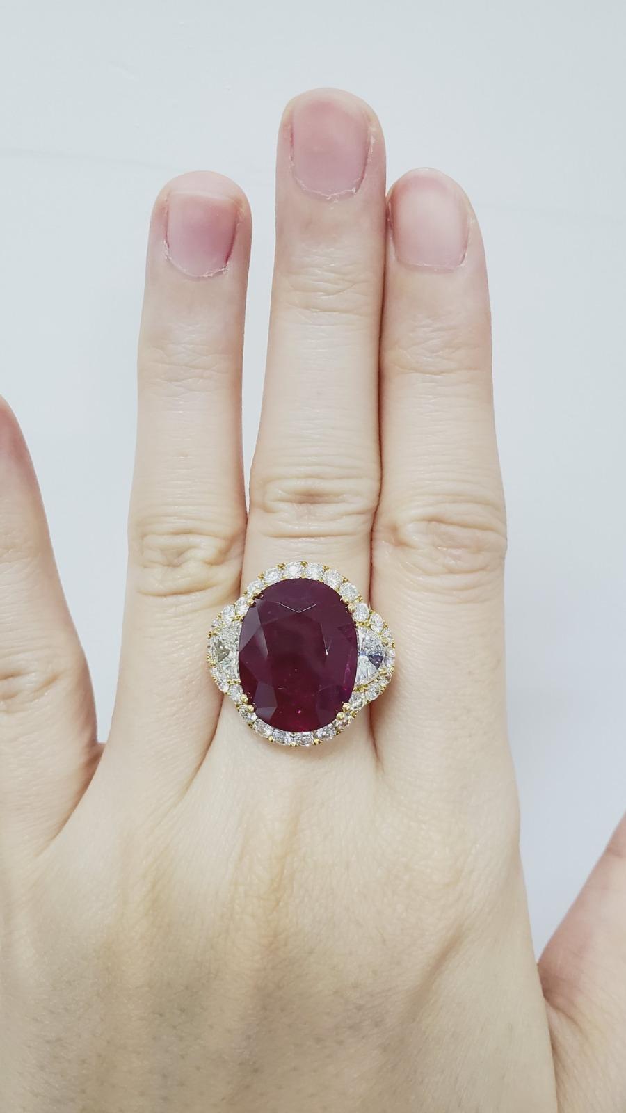 Primary Stone: Red Ruby (Mozambique) 
Shape : Oval Cut
Ruby Weight: 12.52 Carats 
Measurements Ruby : 17.32 x 13.55 x 6.18mm
Color: Red Ruby 
Accent Stones: Genuine Diamond
Shape Or Cut Diamond:
Average Color/clarity Diamond: F/G VS
Composition: