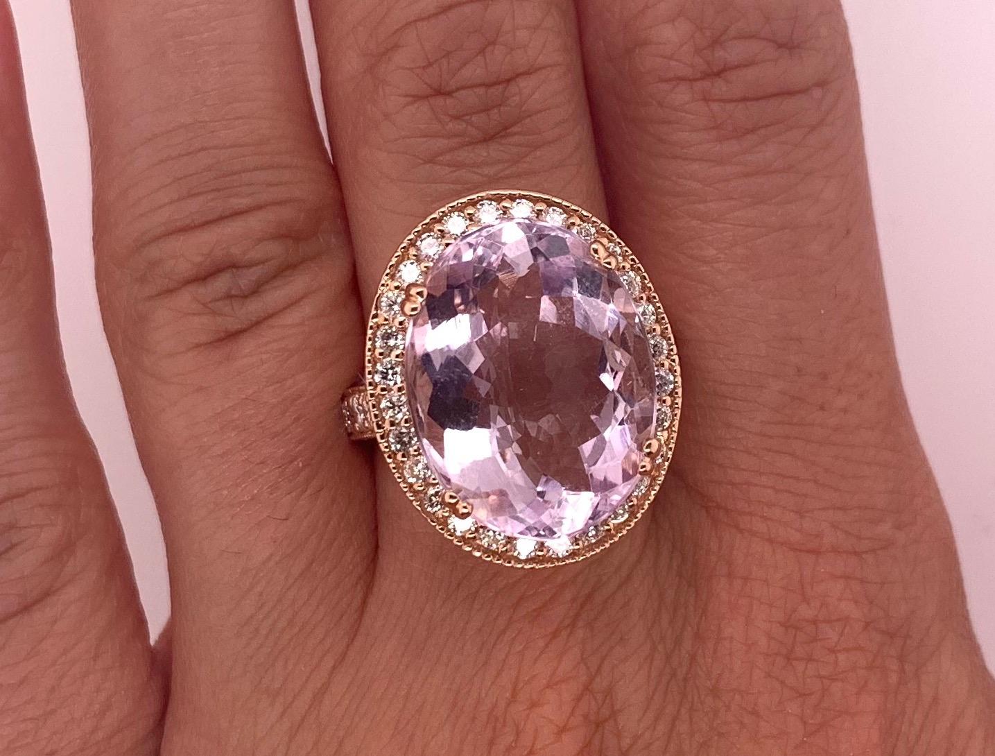 Material: 14k Rose Gold 
Center Stone Details: 1 Oval Shaped Kunzite at 12.53 Carats Total- Measuring 18 x 14 mm
Mounting Diamond Details: 34 Brilliant Round White Diamonds at 0.95 Carats - Clarity: SI / Color: H-I
Ring Size: Size 7 (can be