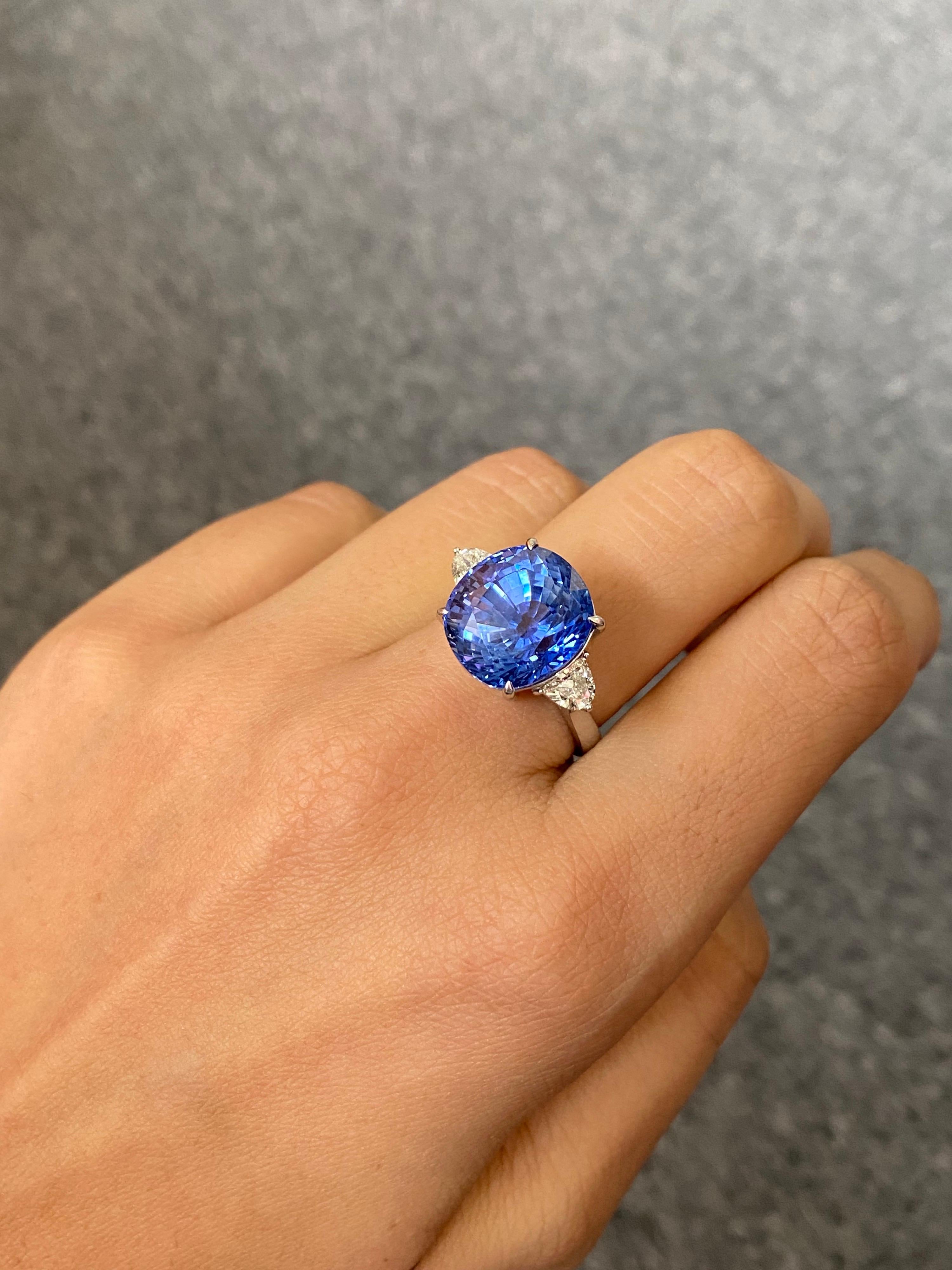 A stunning, 12.57 carat natural Ceylon (Sri Lankan) Sapphire and 0.51 carat VS quality White Diamond three-stone cocktail ring, set in 18K White Gold. The Blue Sapphire is absolutely transparent, has an amazing luster and ideal colour. The ring is